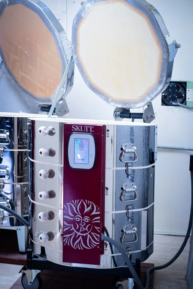 Medical laser cabinet with two large open laser chambers and a control panel on the front labeled SKUT, with a lion logo design.