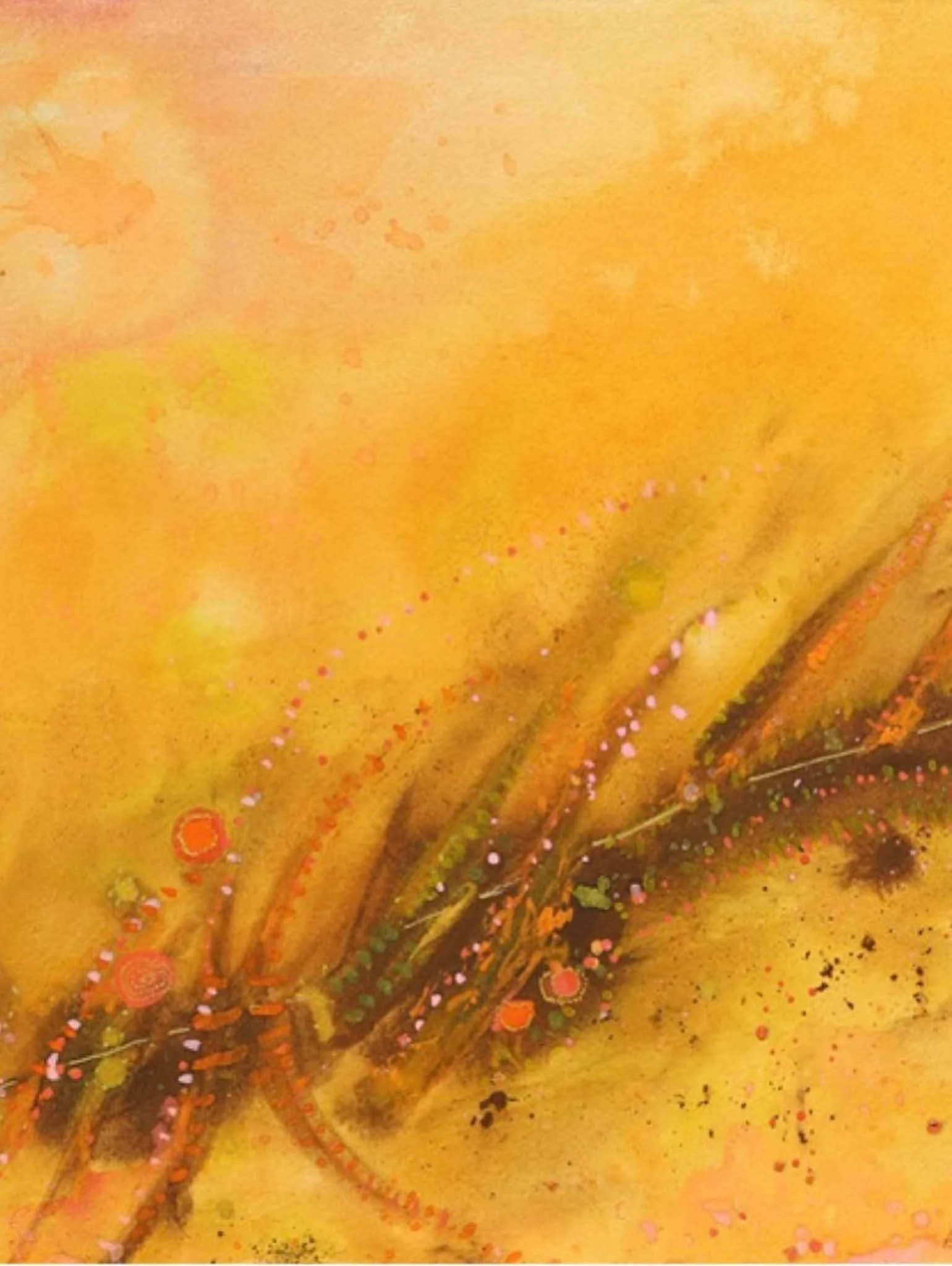 Close-up of a yellow and orange abstract painting with splatters and textured details.