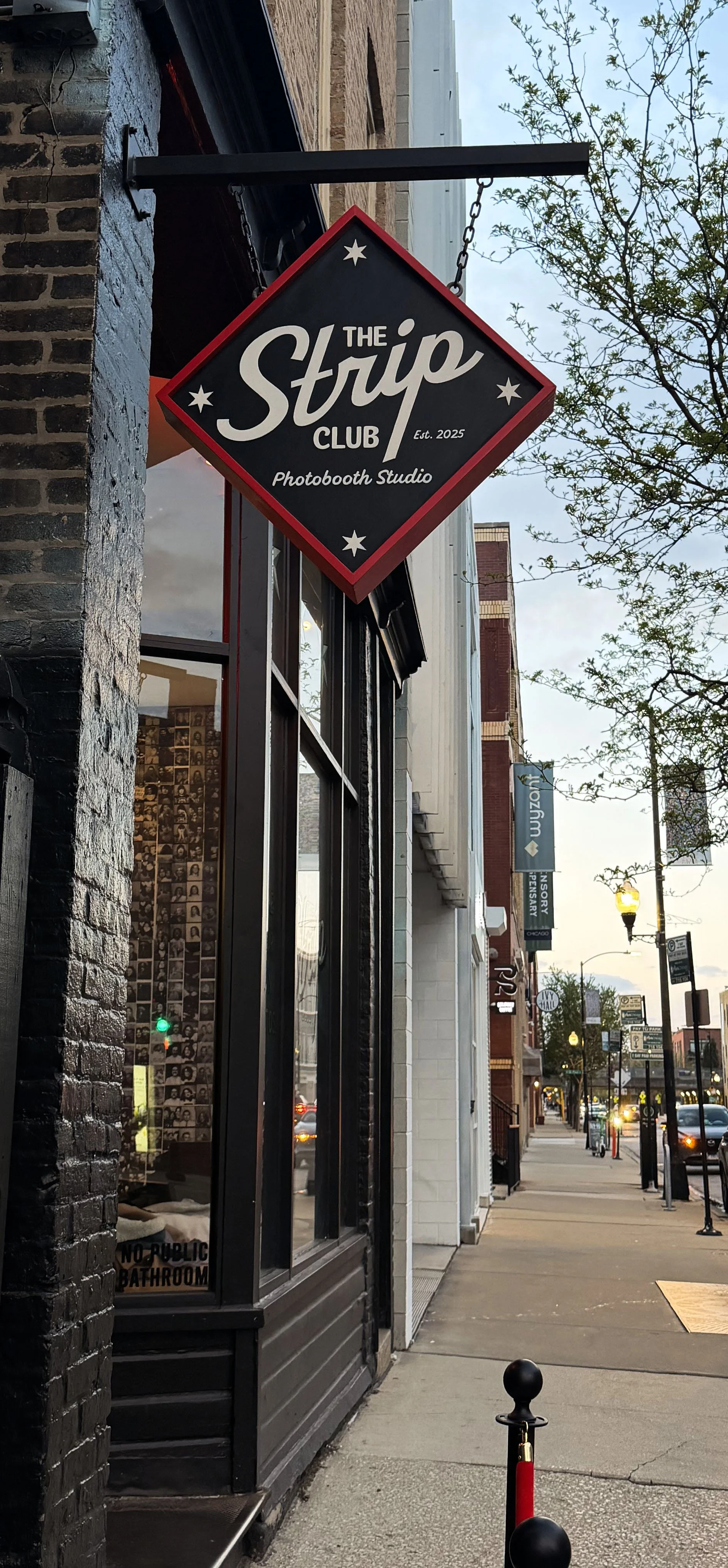 Exterior of The Strip photobooth studio on a Chicago street in Wicker Park at dusk.