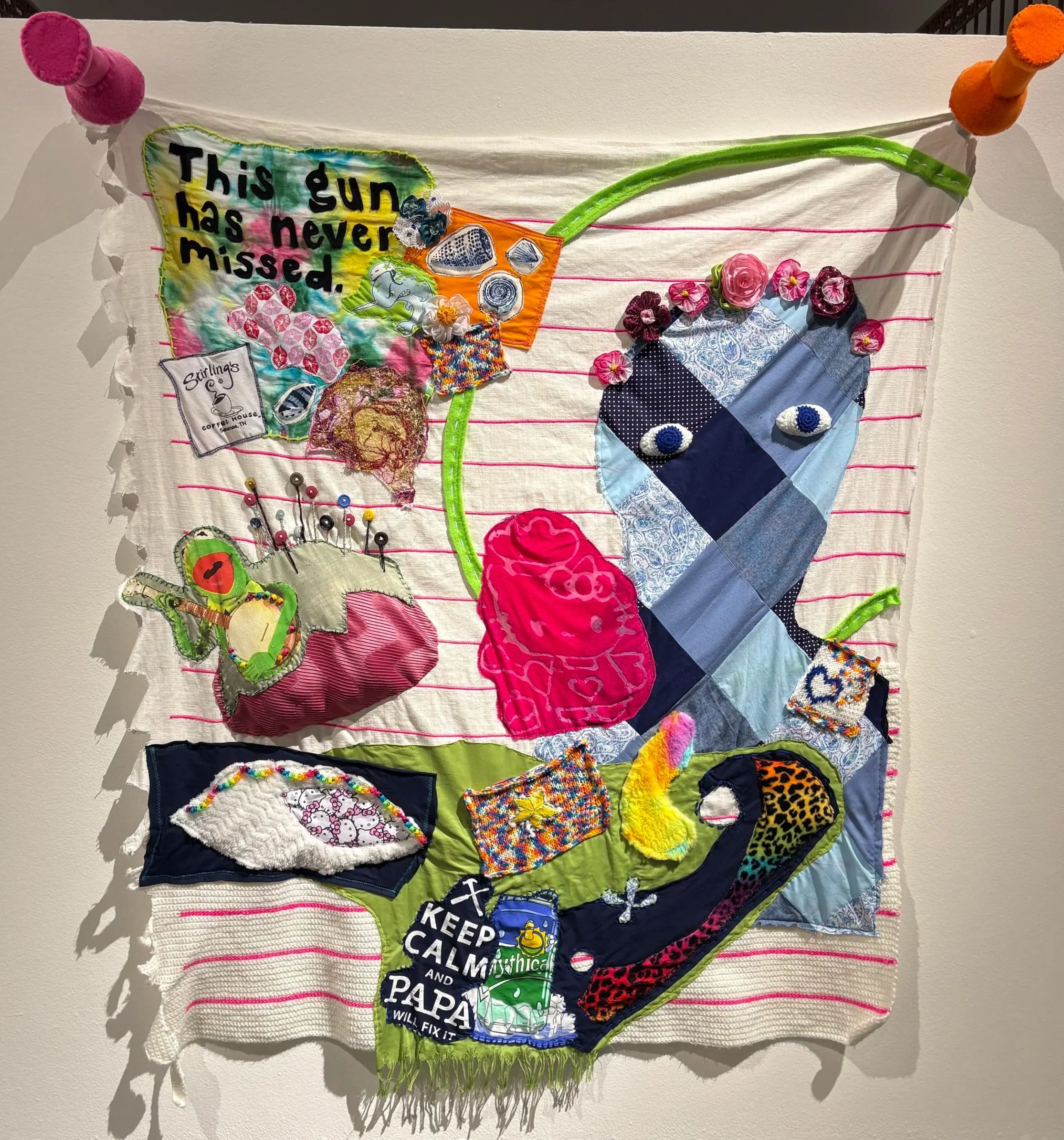 This Gun Has Never Missed. 2026. Cotton, yarn, recycled t-shirts, recycled hand-knit squares, scrap fabric, fleece, faux fur, ribbon, beads, buttons, embroidery thread, cardboard, memory foam, (61in x 55in x 9.5 in)