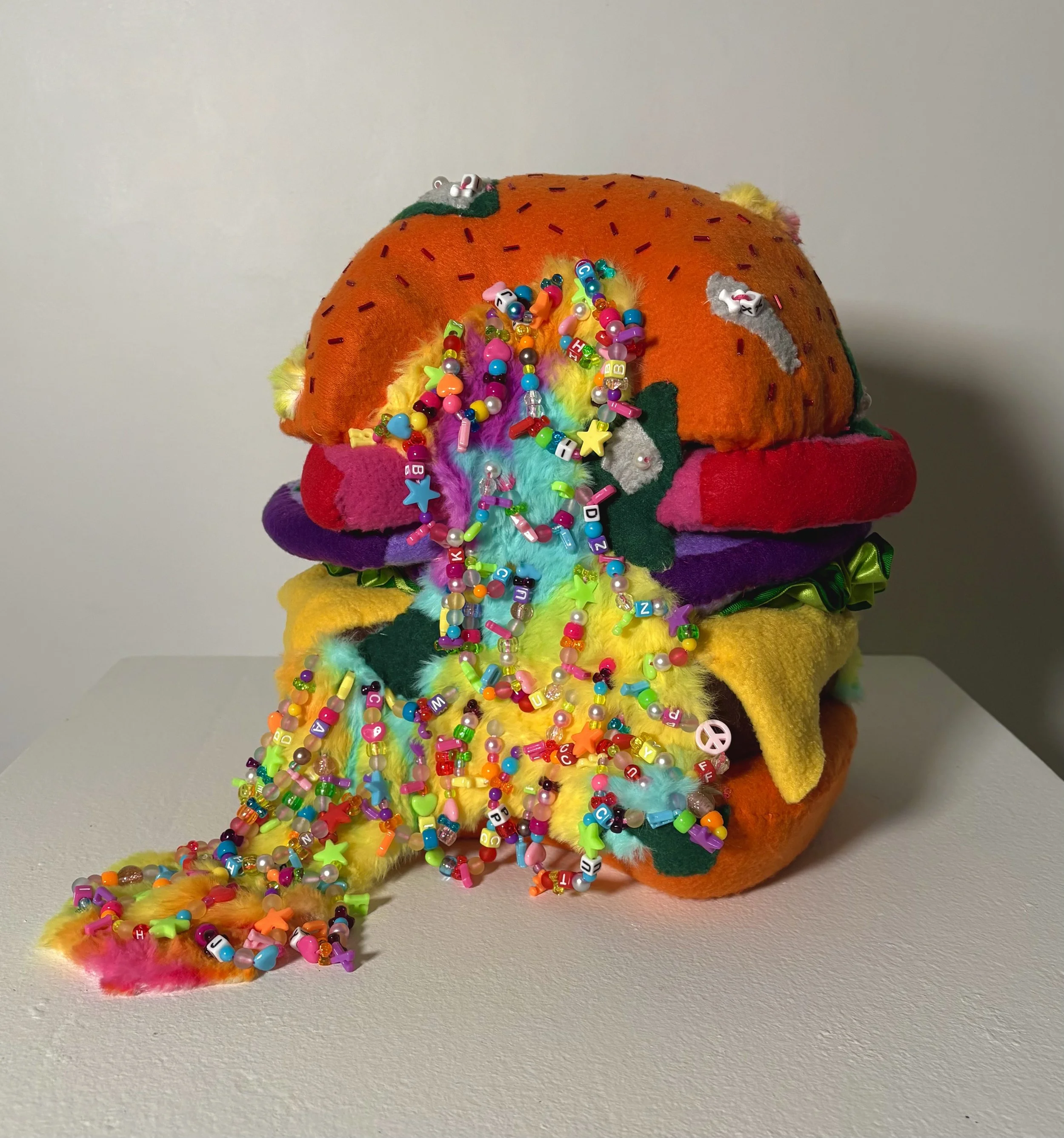 Epic Burger with Awesome Sauce, 2025. Memory foam, cardboard, fleece, faux fur, beads, ribbon, embroidery thread, (12in x 10in x 10in)