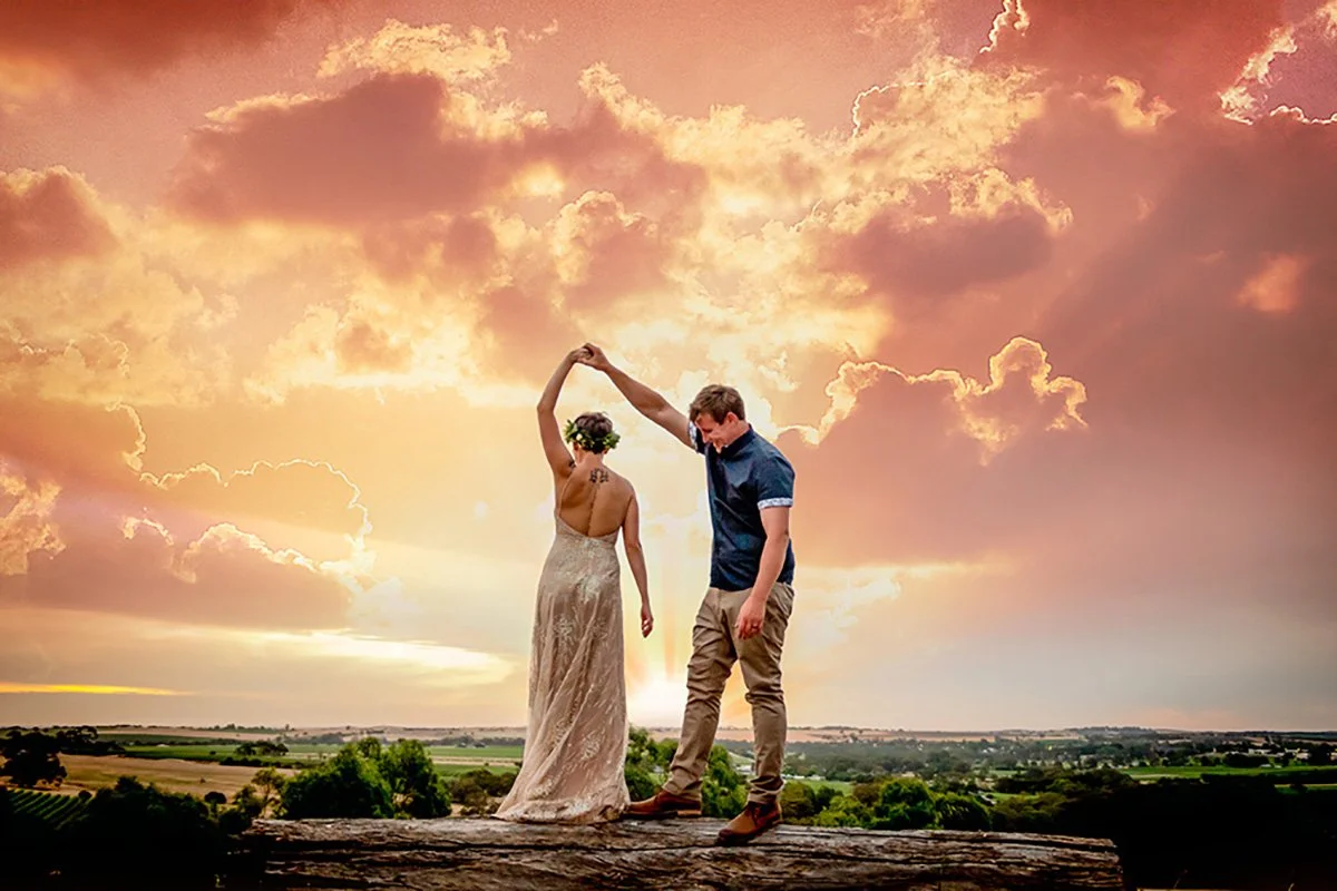 Laurie’s customers, Mariana and Carmen holding hands on a green lawn on their wedding day.