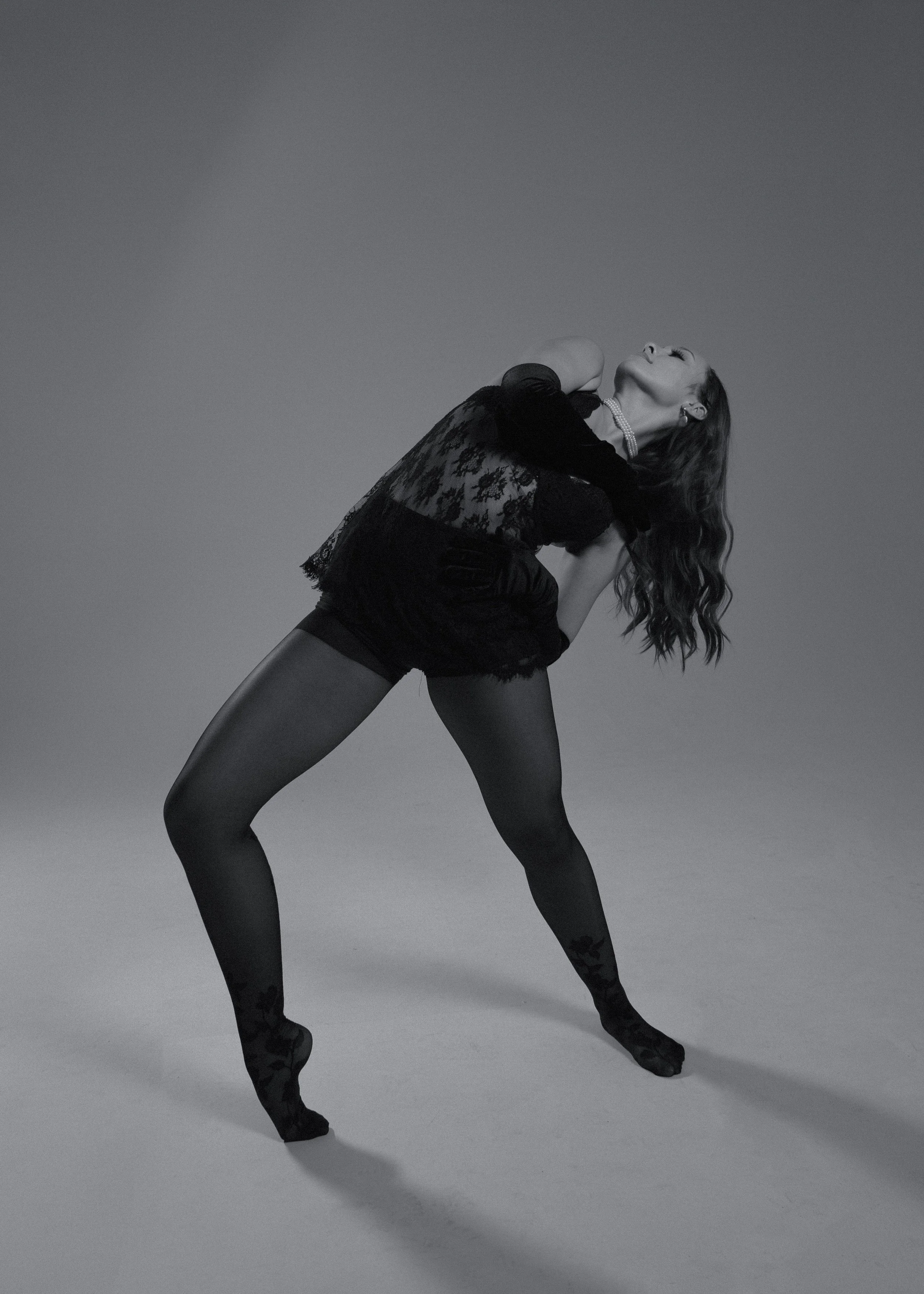 Samantha Scott, a young female dancer in a black dress with long wavy hair