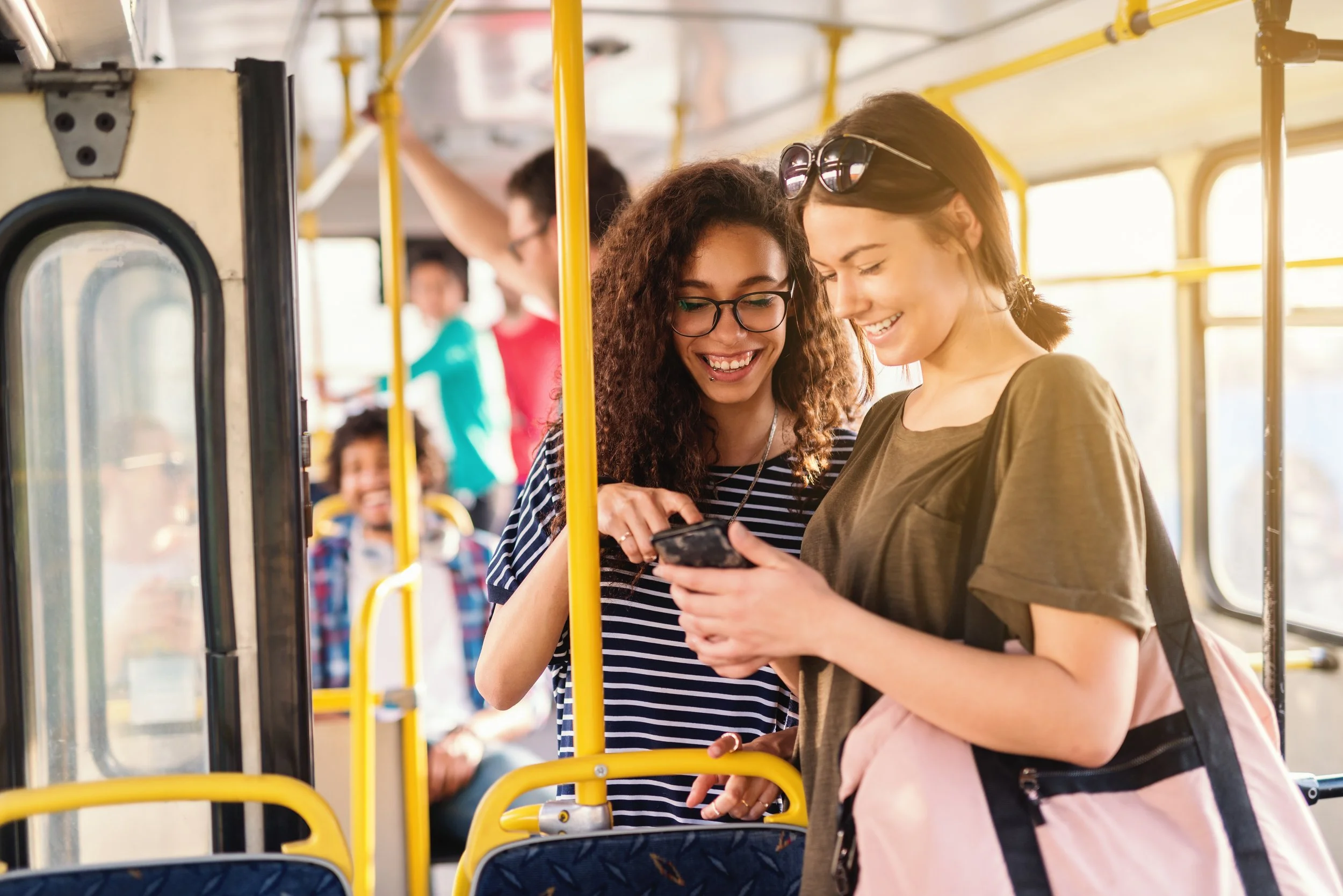 Two friends engaging with one another on the train.