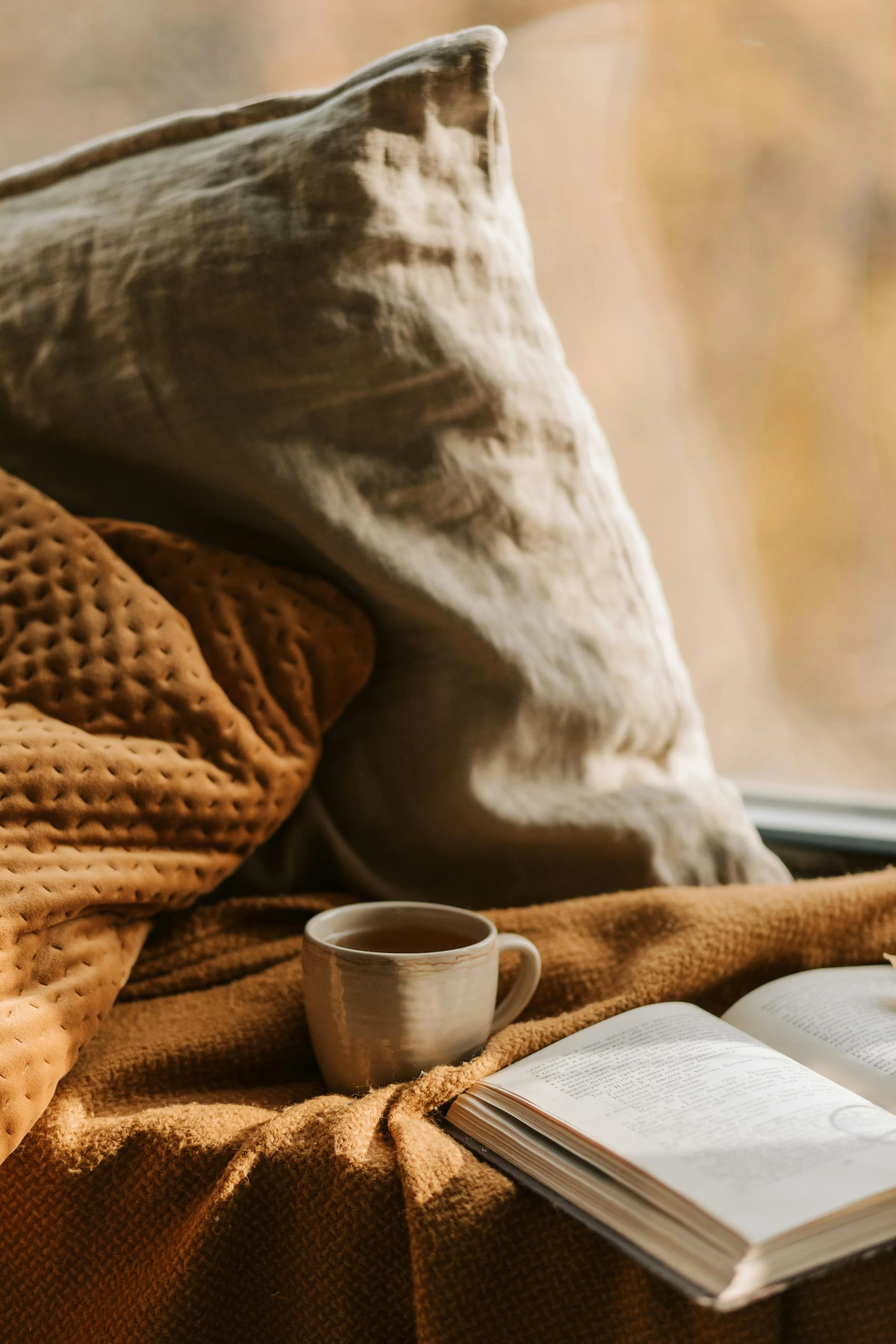 A cozy and reflective space, with a warm beverage and open journal.