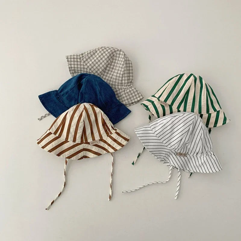 Four baseball caps with different patterns and colors arranged on a white surface.