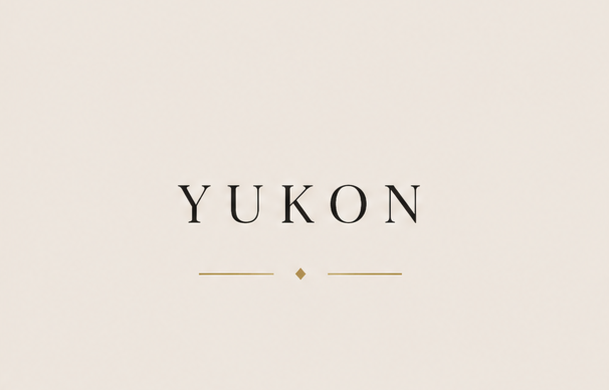 Text reading 'Yukon' with a small dot and lines above and below, on a plain background.