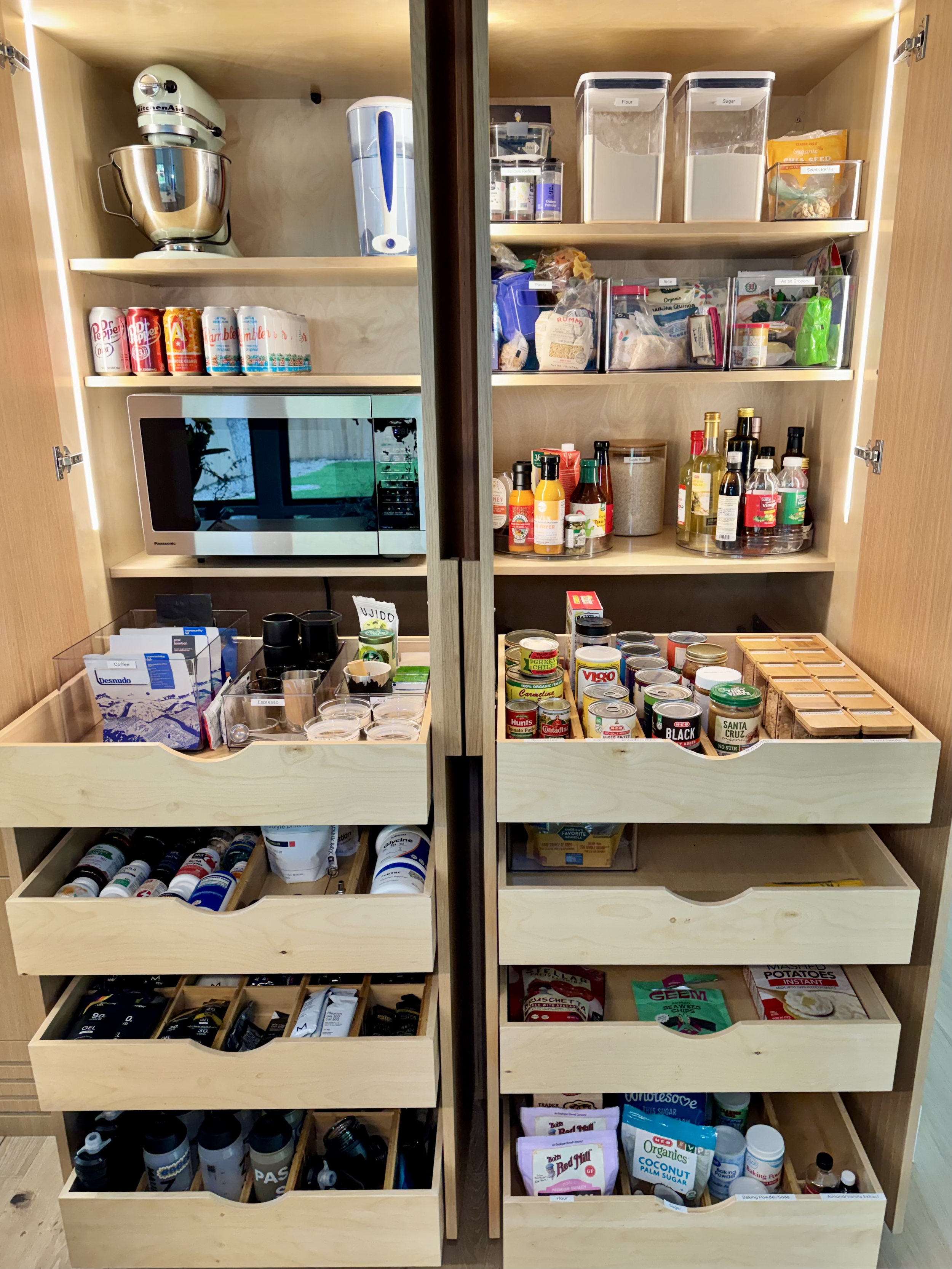 Open kitchen pantry with shelves neatly organized and labeled - pantry organization, kitchen organization, professional home organizing services in Austin TX by Ordered Living Co