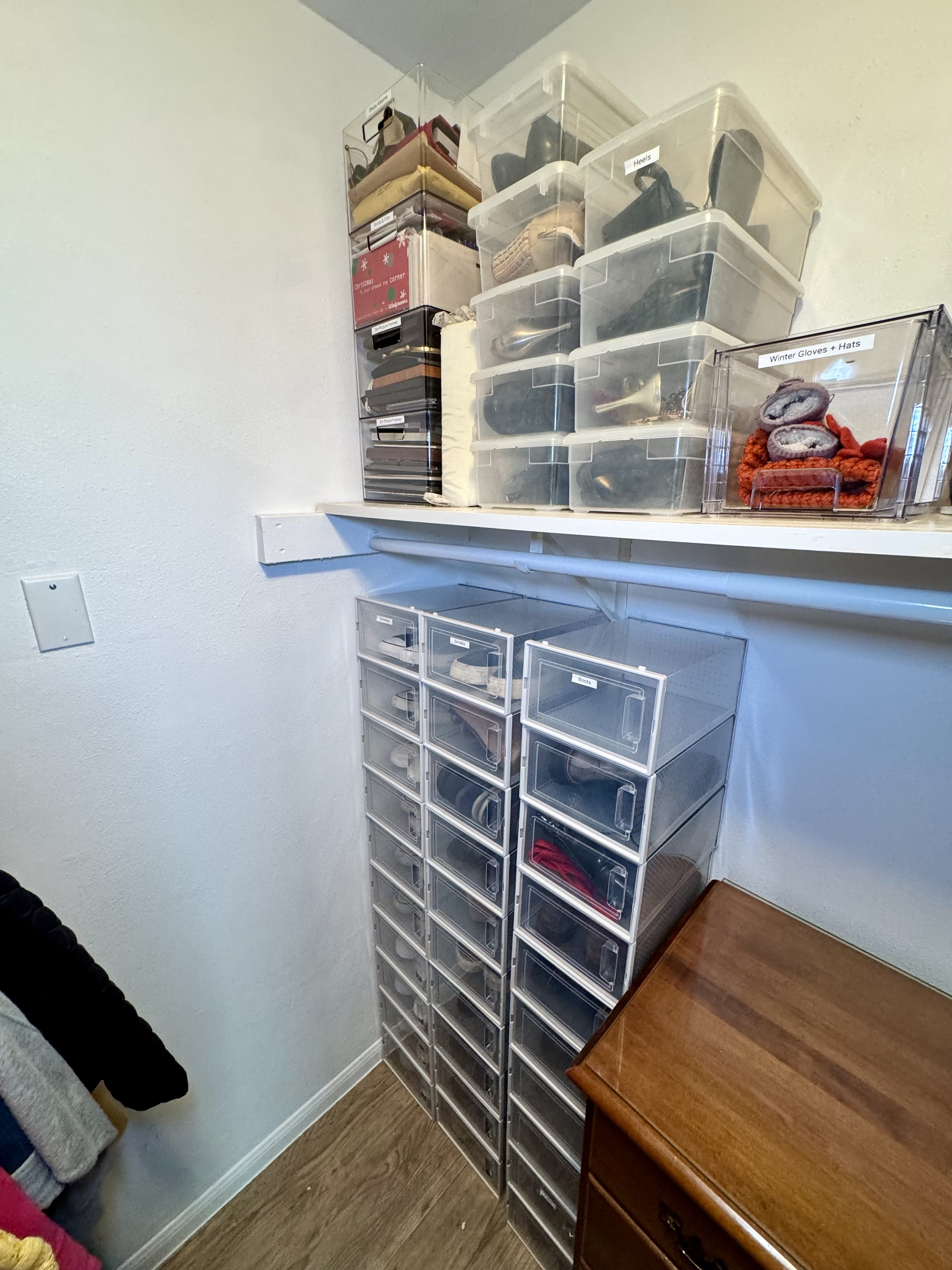 Closet organization with clear, matching, and labeled bins for shoe and accessories organization - professional home organizing services in Austin TX by Ordered Living Co