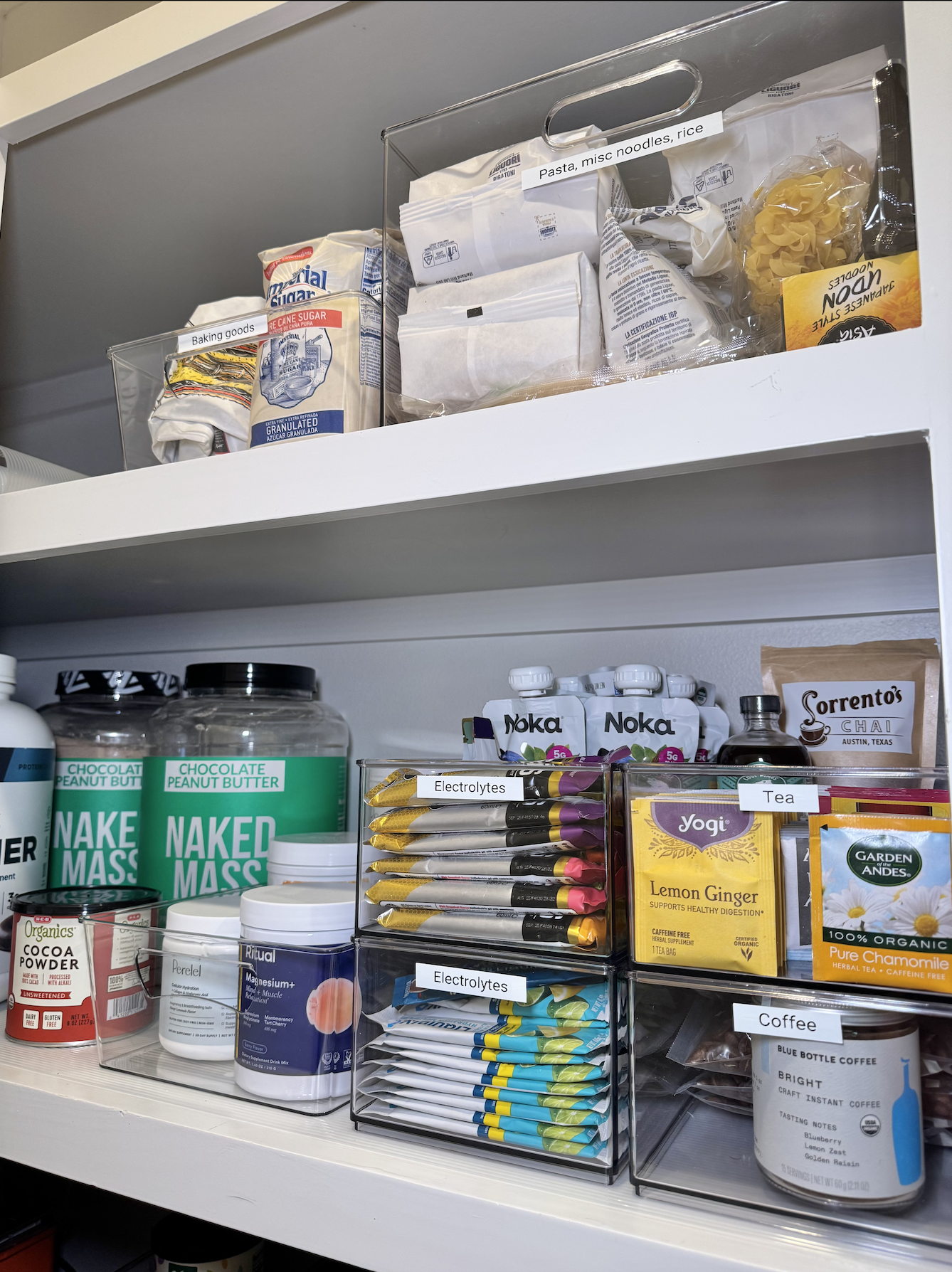 Pantry shelf organization, supplements, baking goods, electrolytes, tea, and coffee organization, clear bins organization - professional pantry organization services by Ordered Living Co. in Austin TX