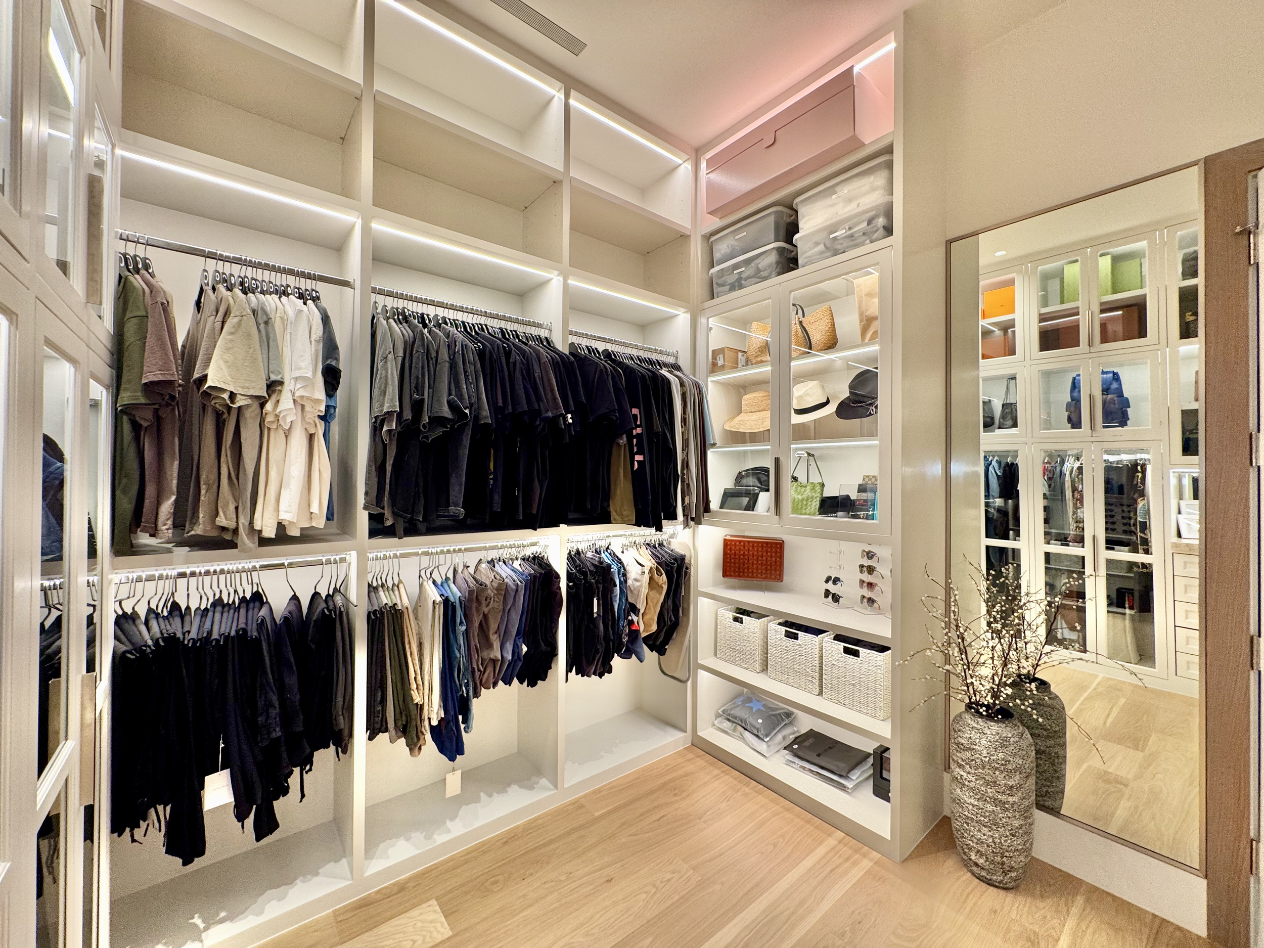 Professionally organized walk-in closet with categorized hanging sections, shelving, and accessory storage — Ordered Living Co. Austin TX
