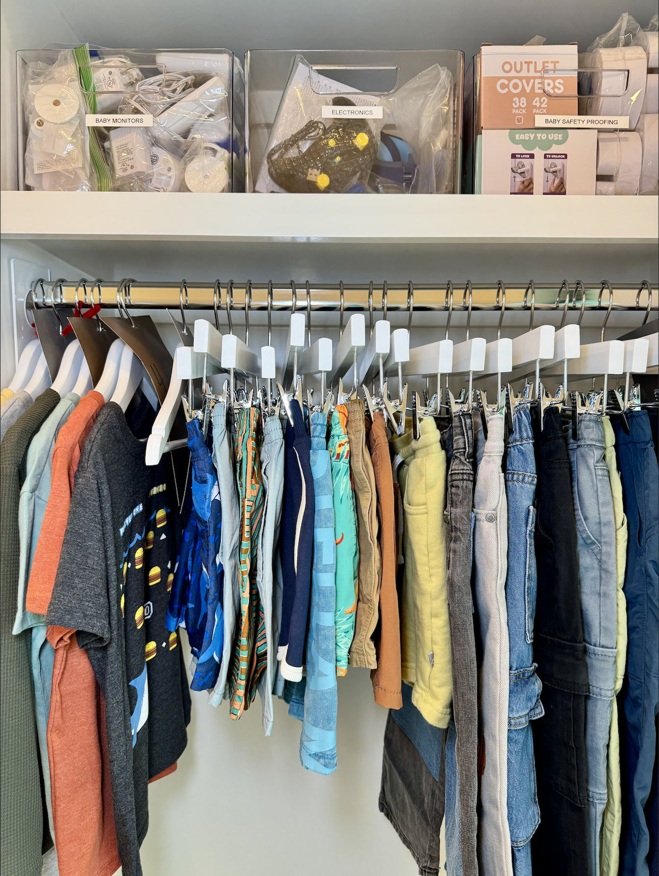 Professionally organized kid's closet with categorized storage bins and labeled sections — home organization services by Ordered Living Co. Austin TX