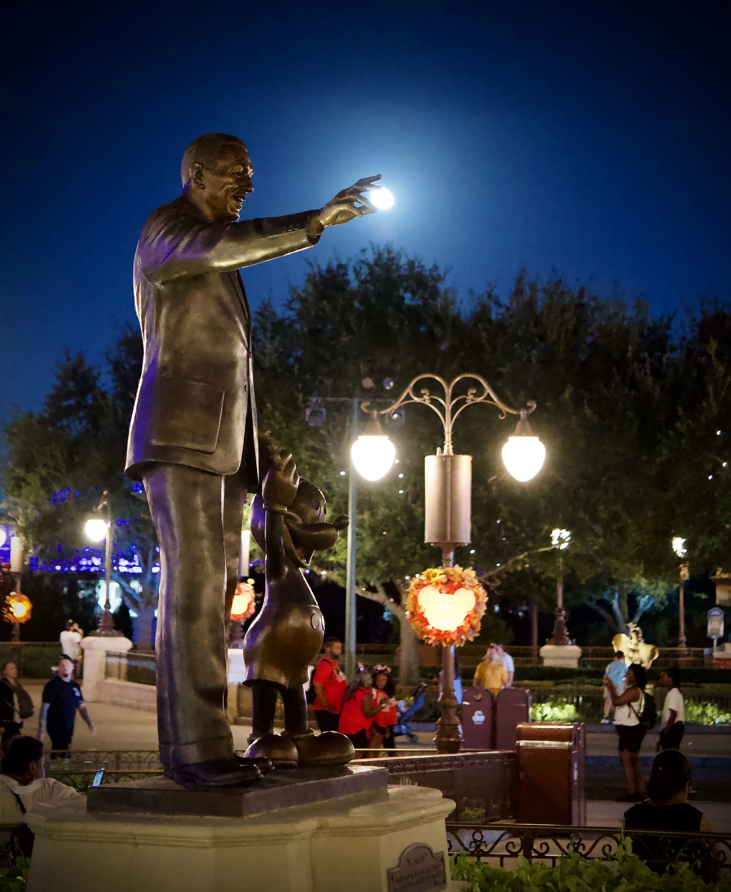 Walt Disney adjusting the moon at Magic Kingdom