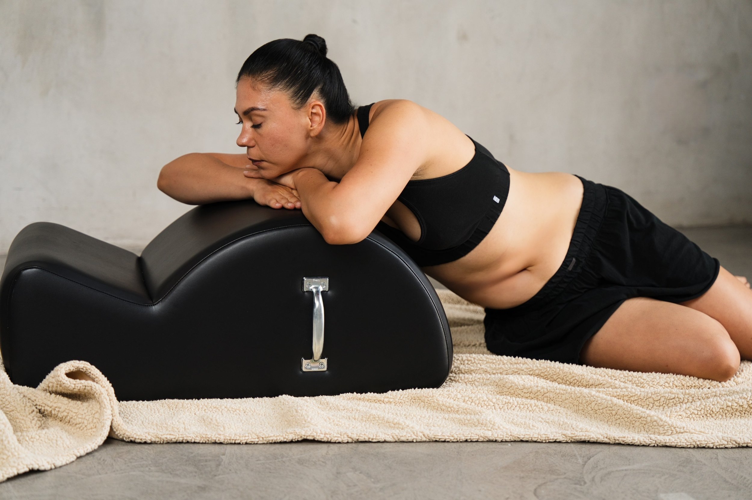 A woman resting over a Gratz Spine Corrector