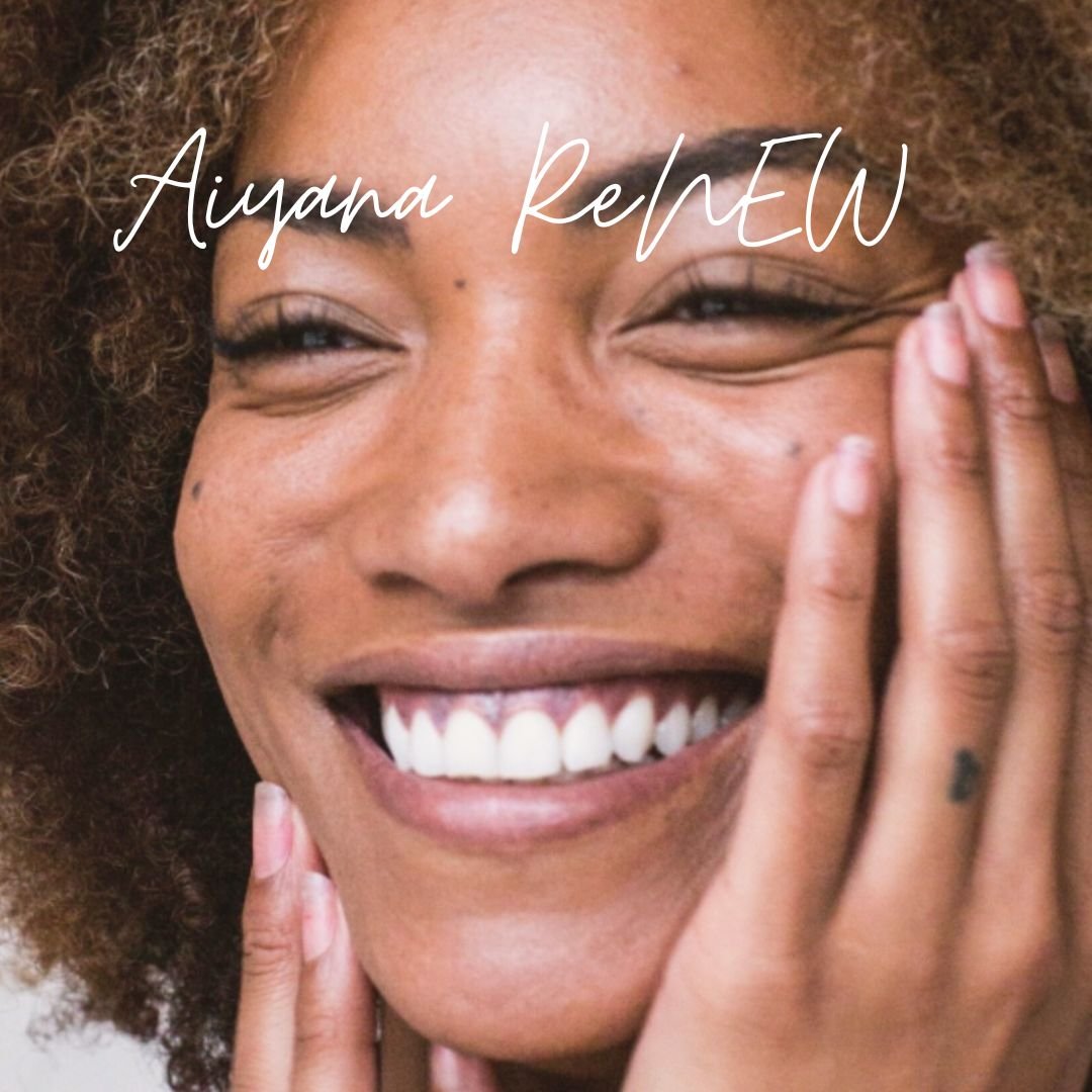 Close-up of a smiling woman with curly hair, touching her face with her hand, with text overlay reading 'Aiyana ReNEW'.