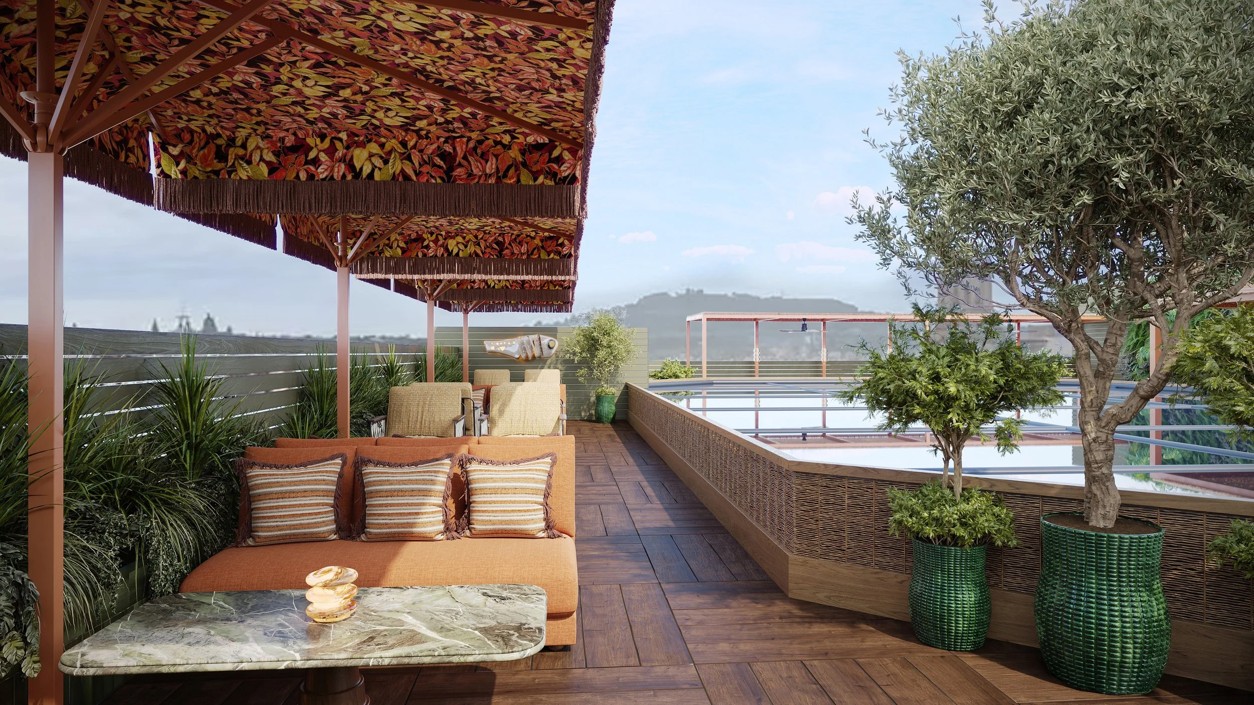 Rooftop patio with table, chairs, sofa, umbrellas, plants, and trees, overlooking distant mountains and blue sky.