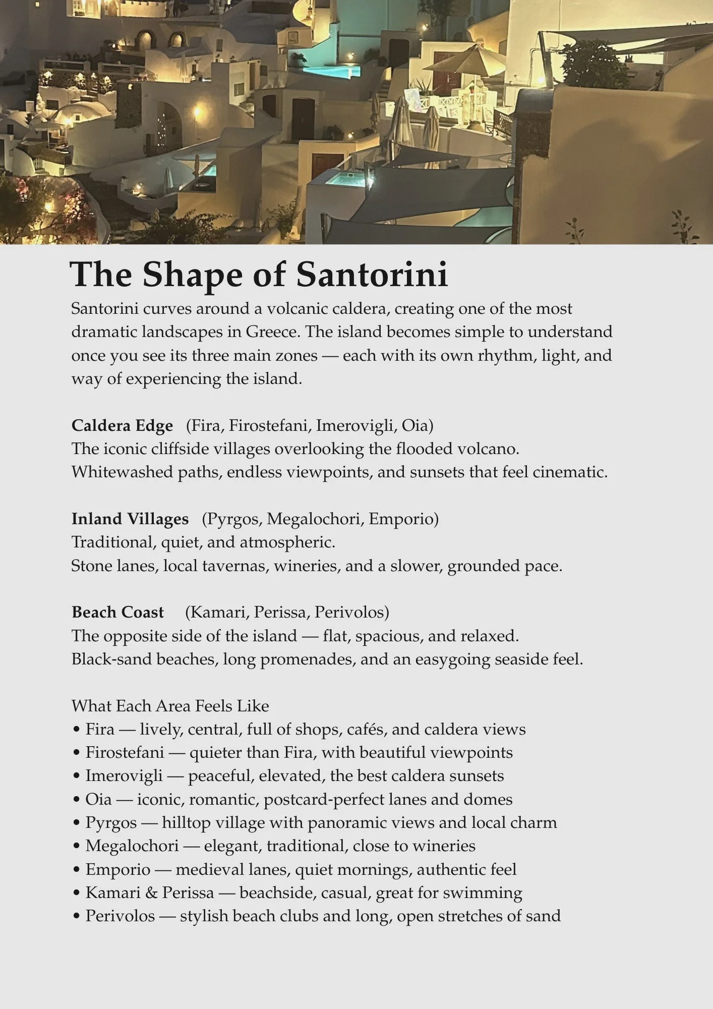 Nighttime view of Santorini with white buildings, pools, and outdoor seating areas illuminated by warm lights.