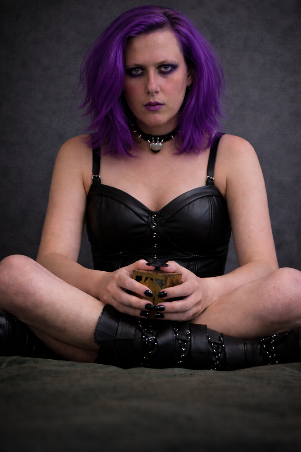 Purple-haired woman in leather bustier.png