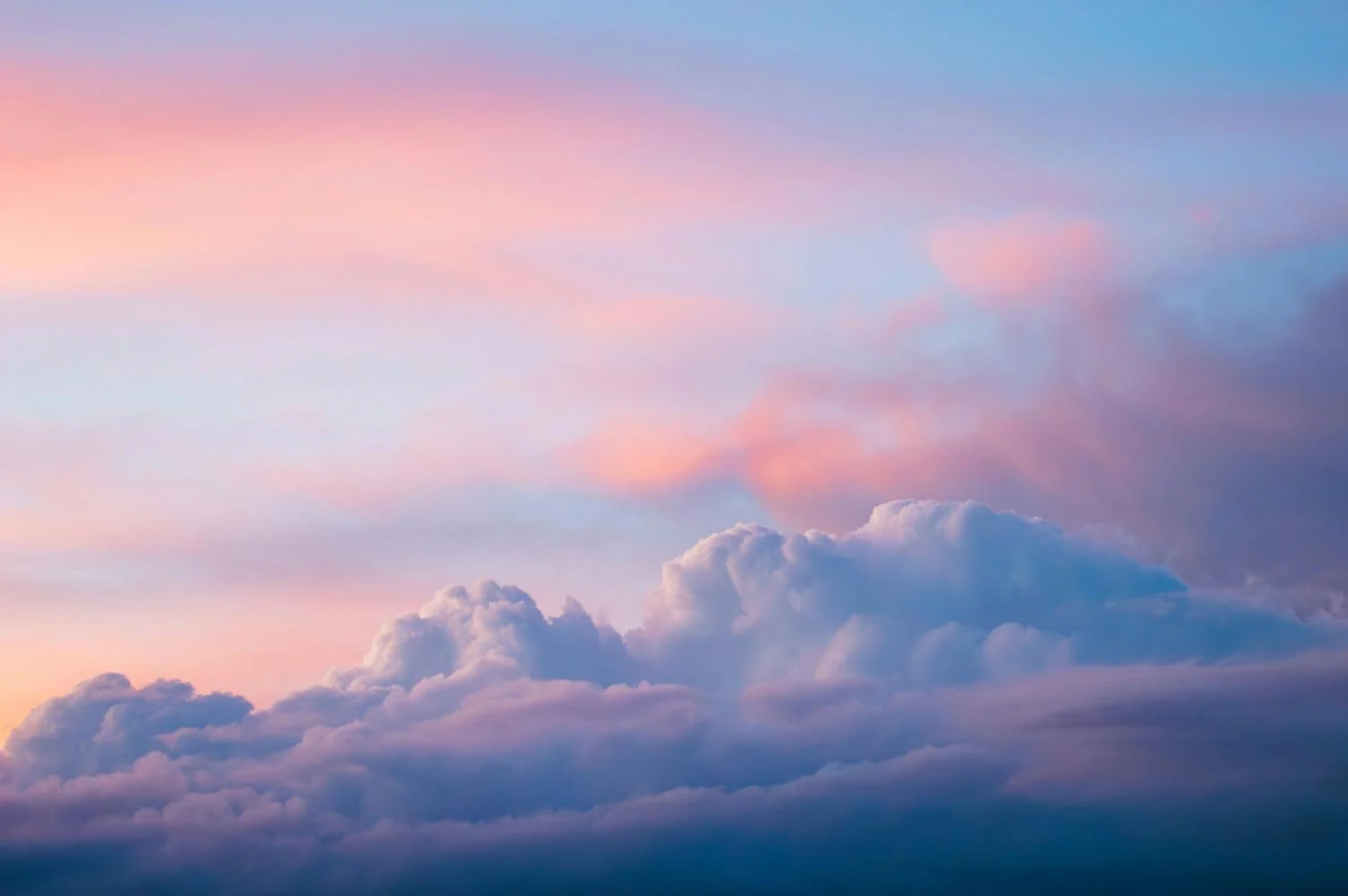Colorful sky during sunset with pink, purple, and blue clouds.
