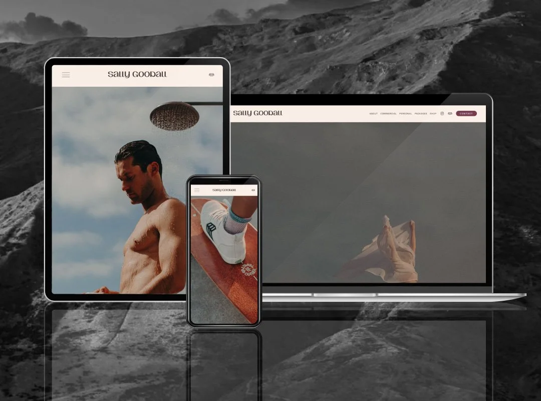 Multiple electronic devices displaying a personal website against a rocky mountain background