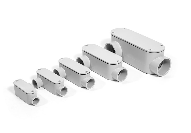 Series of white electrical junction boxes of increasing size, arranged in a line on a white background.