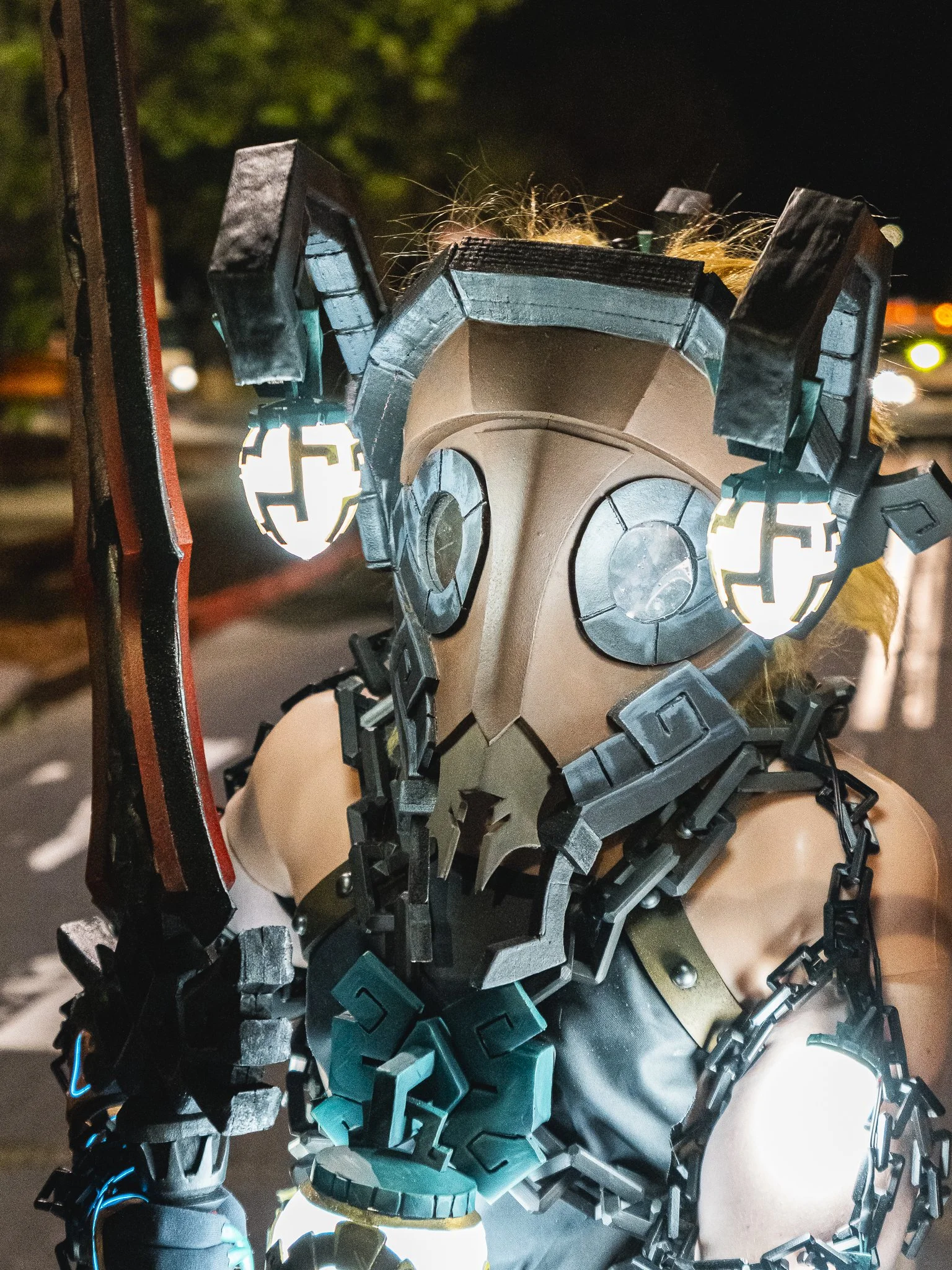 Person dressed in a sci-fi or fantasy costume resembling a robotic or cybernetic character with illuminated elements and intricate detailing.