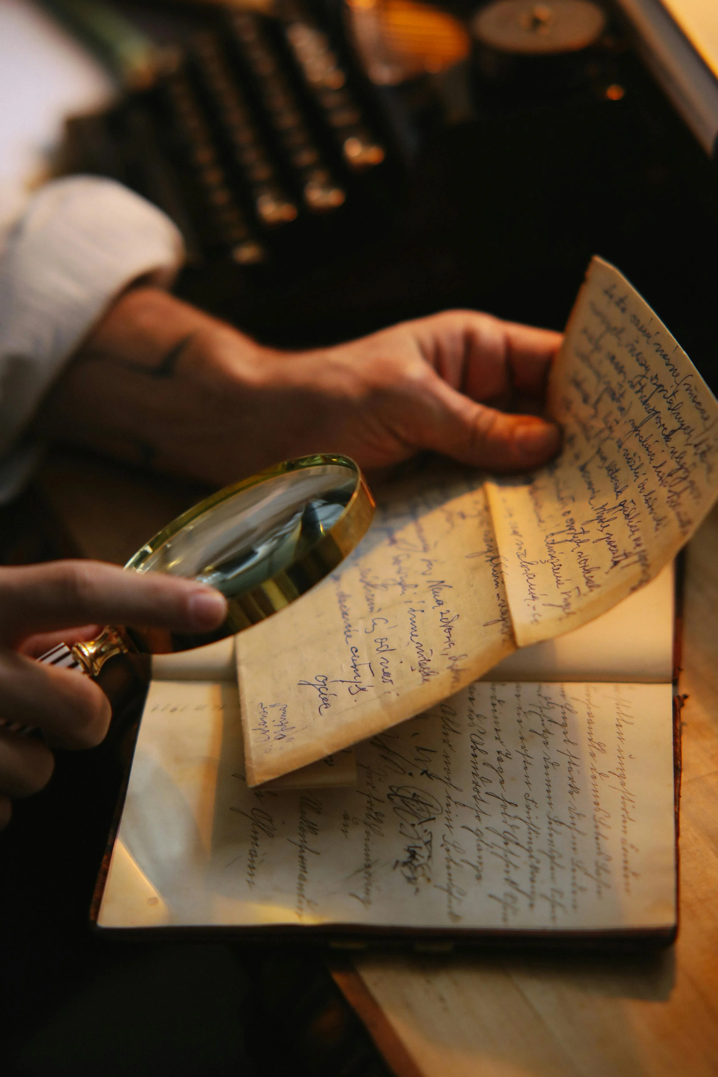 A genealogist examining a handwritten letter with a magnifying glass to find missing genealogical records for Canadian citizenship by descent.