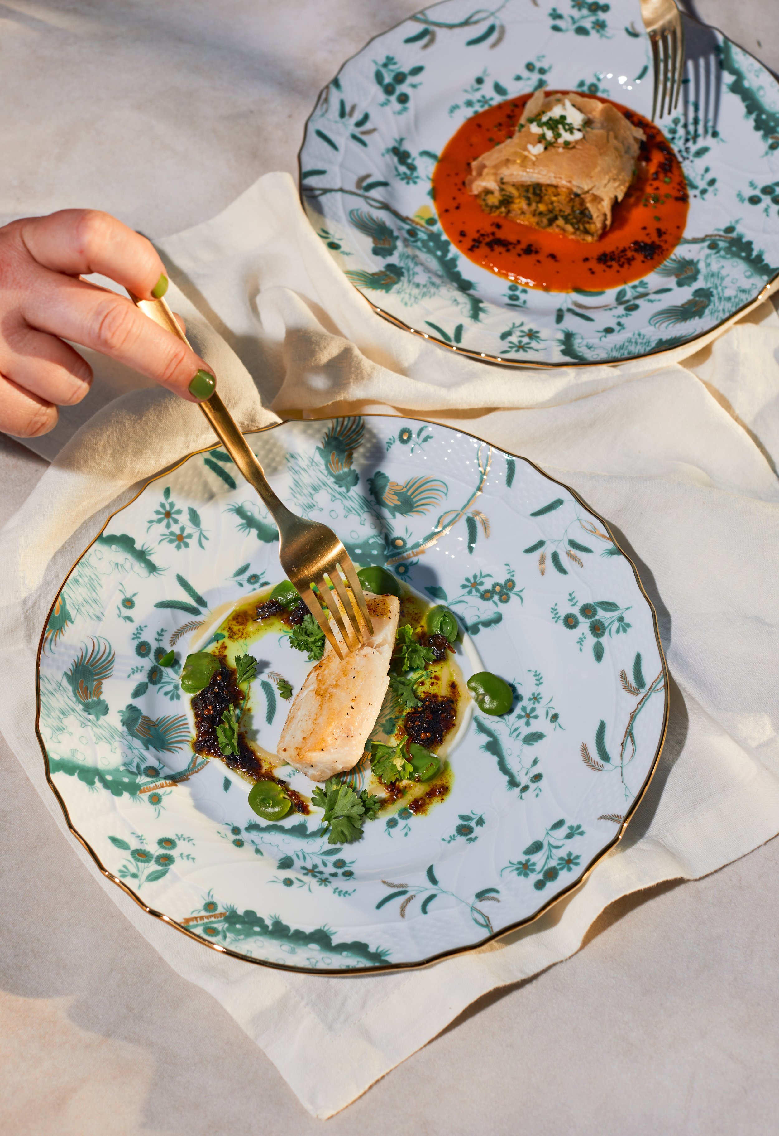 Chef-prepared gourmet fish dish with herbs and sauce.