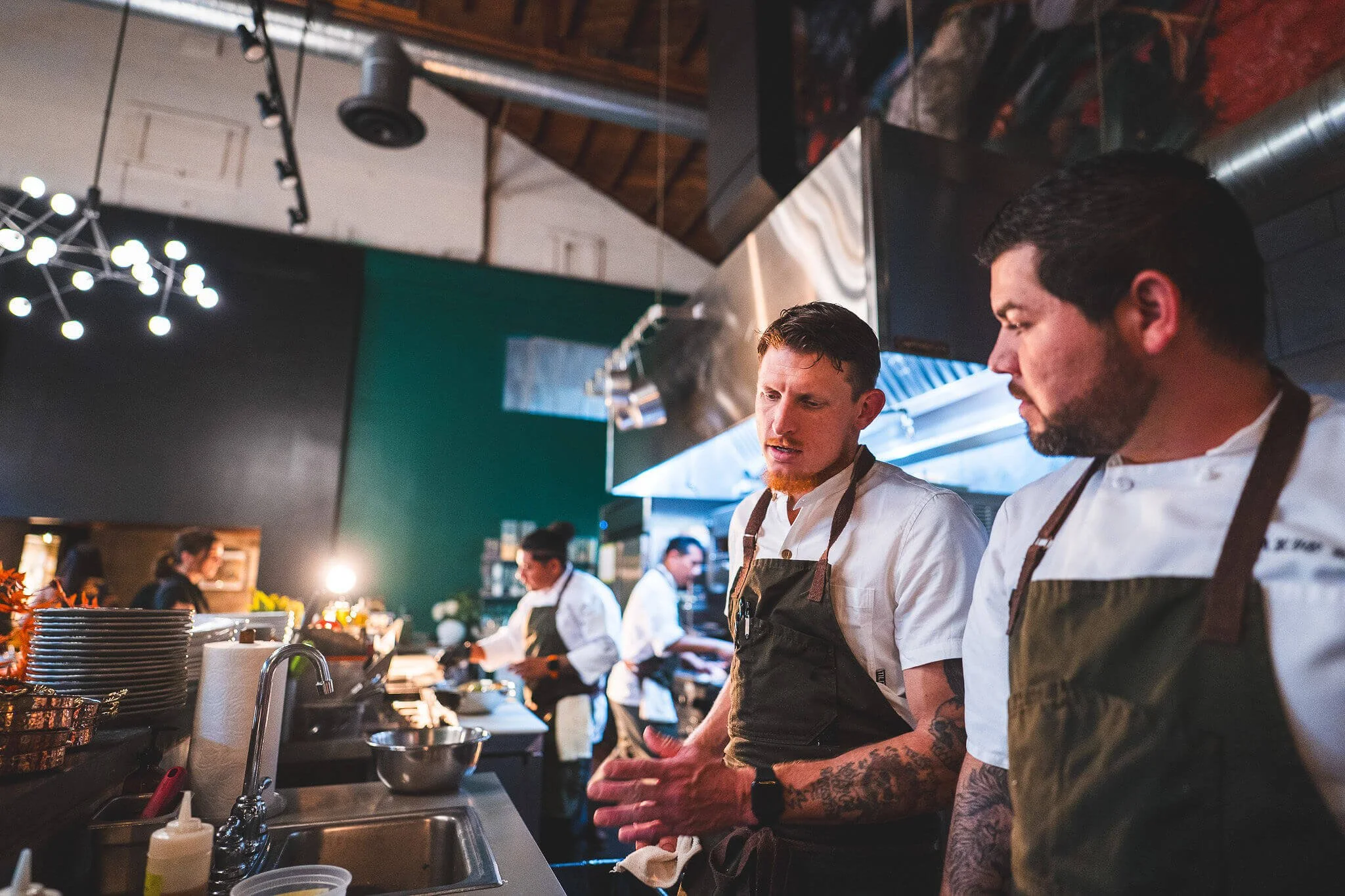 Chefs preparing food in a professional restaurant kitchen in Sonoma, California.