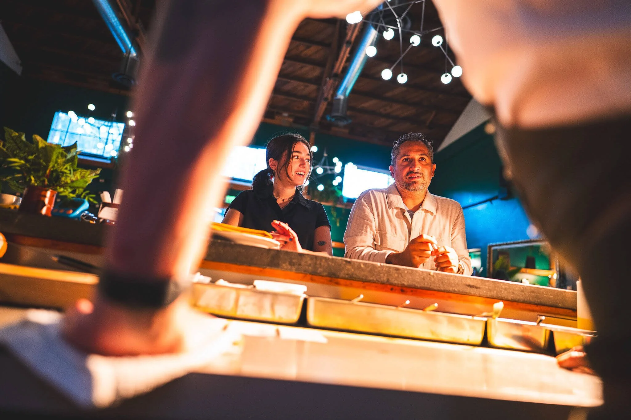 Restaurant manager and staff member speaking at the bar in Sonoma, California.
