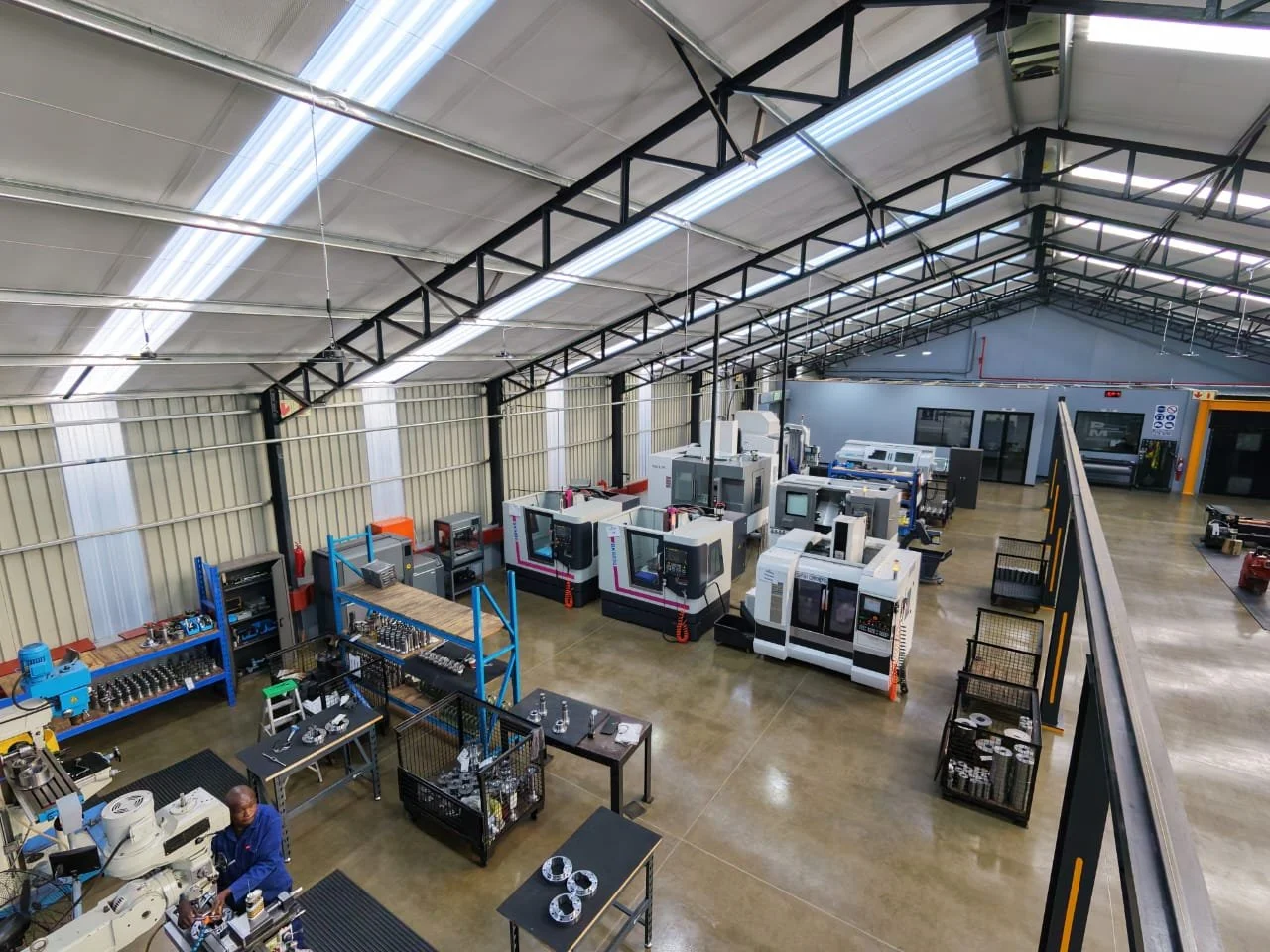 Industrial engineering workshop with precision manufacturing equipment for propshaft repairs, driveline solutions, and driveshaft manufacturing services
