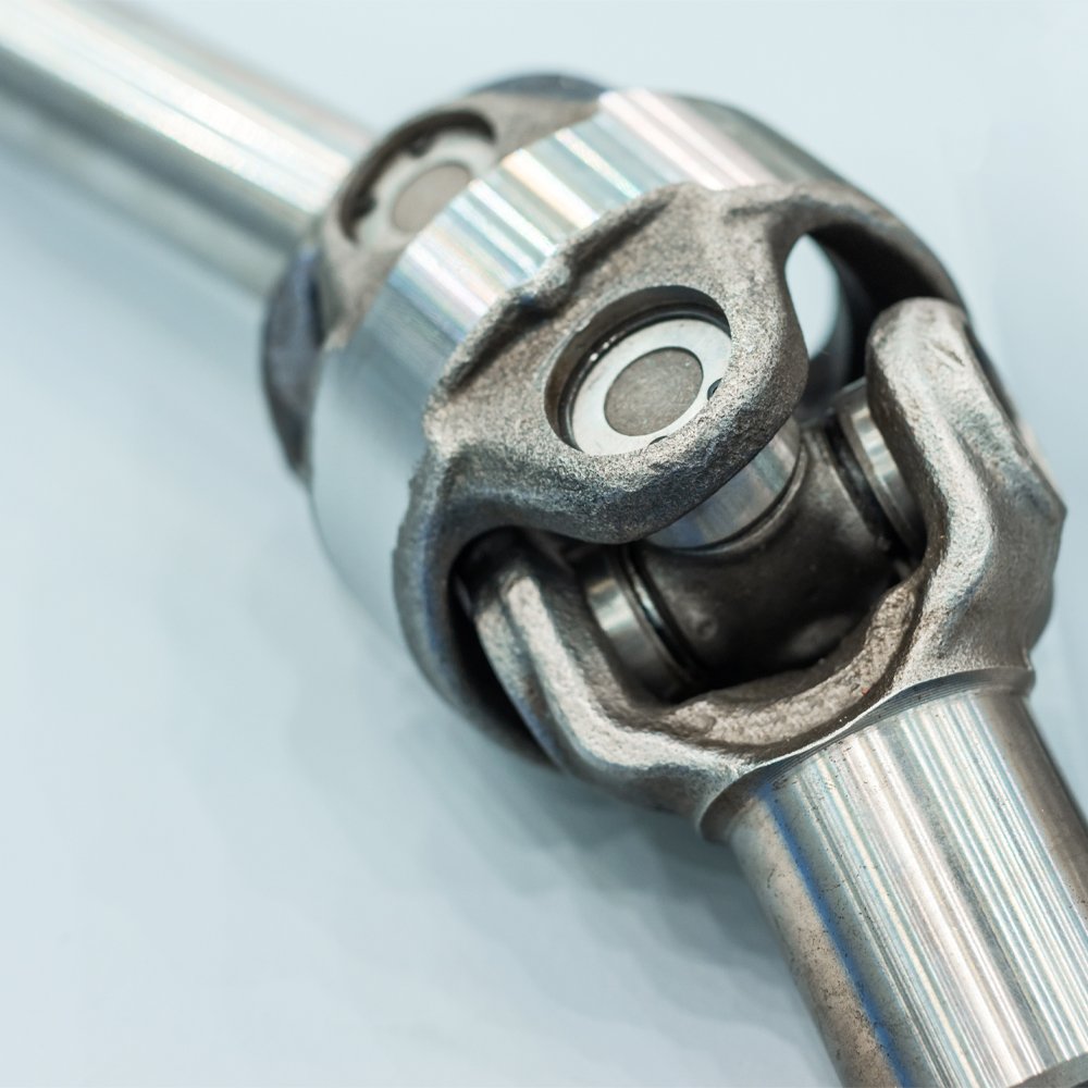Heavy-duty propshaft universal joint that can contribute to driveline vibration when worn or damaged.