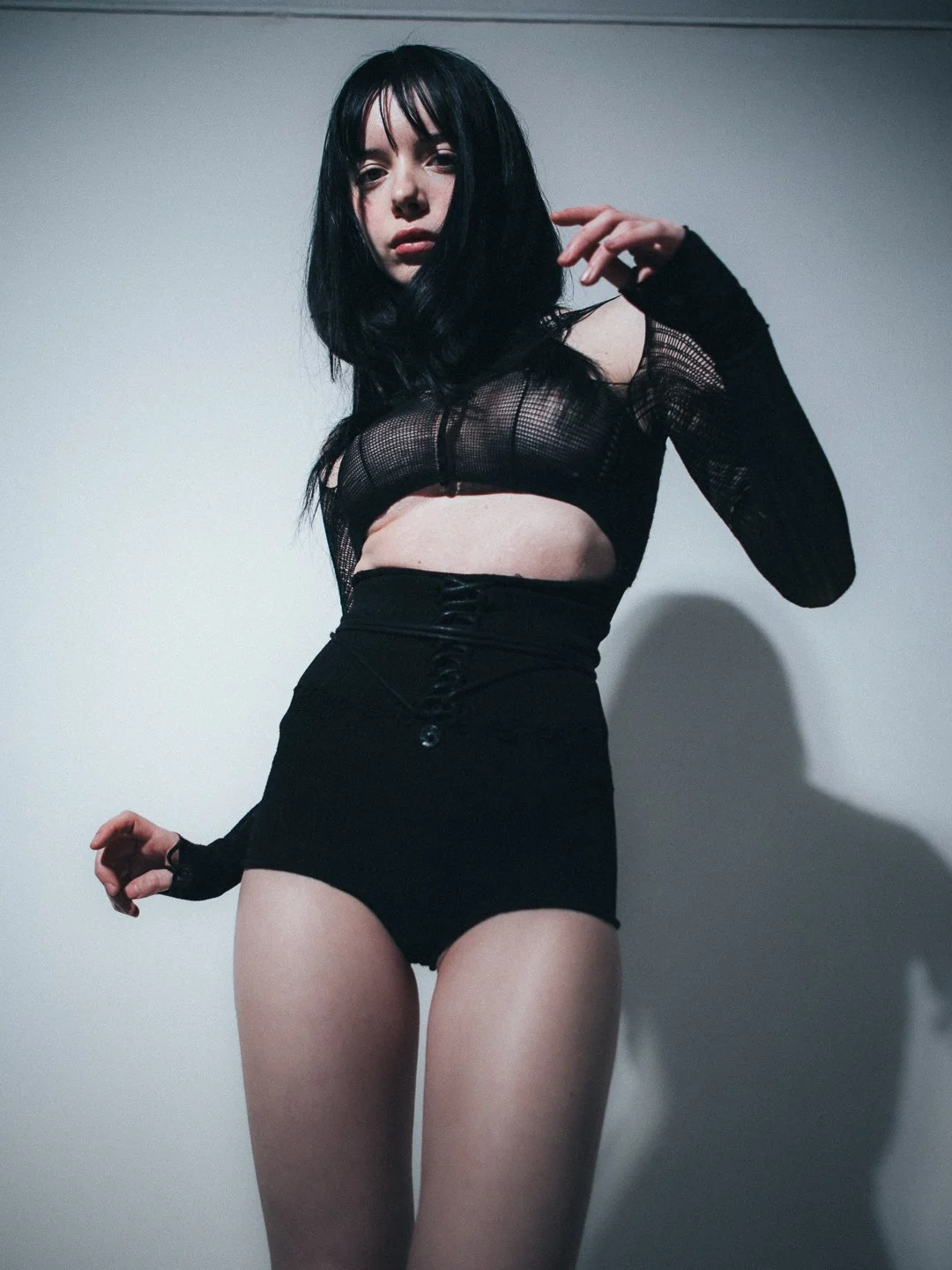 Model in a black avant-garde VOFT knit shapewear bodysuit by Valeriya Olkhova, crafted in an ultra-lightweight, futuristic knit in Denmark at Apotheca Atelier, Odder. Styled by Anca Macavei for Nasty Magazine Italy.