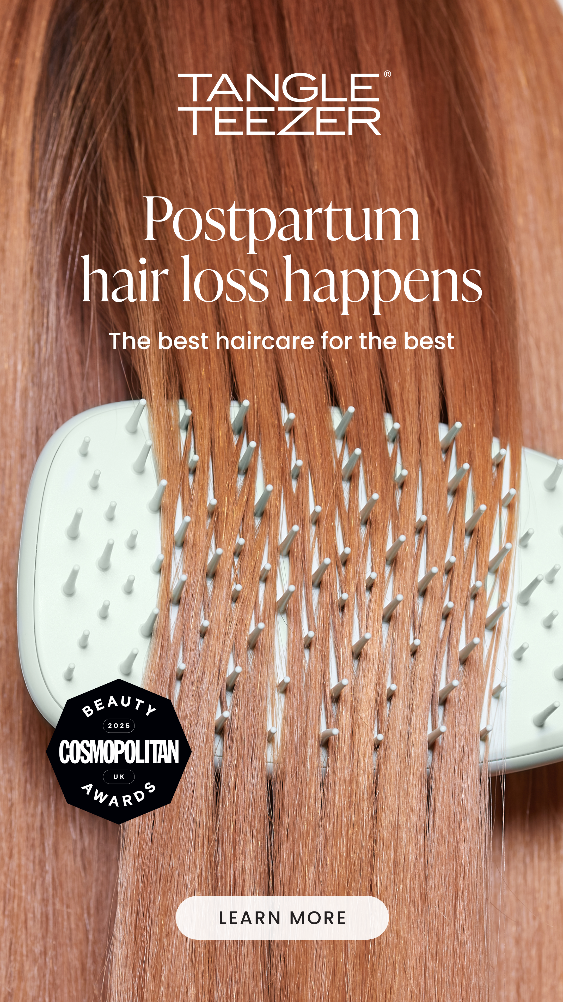 A hairbrush with long, straight, red hair running through it, advertising a hairbrush for postpartum hair loss.