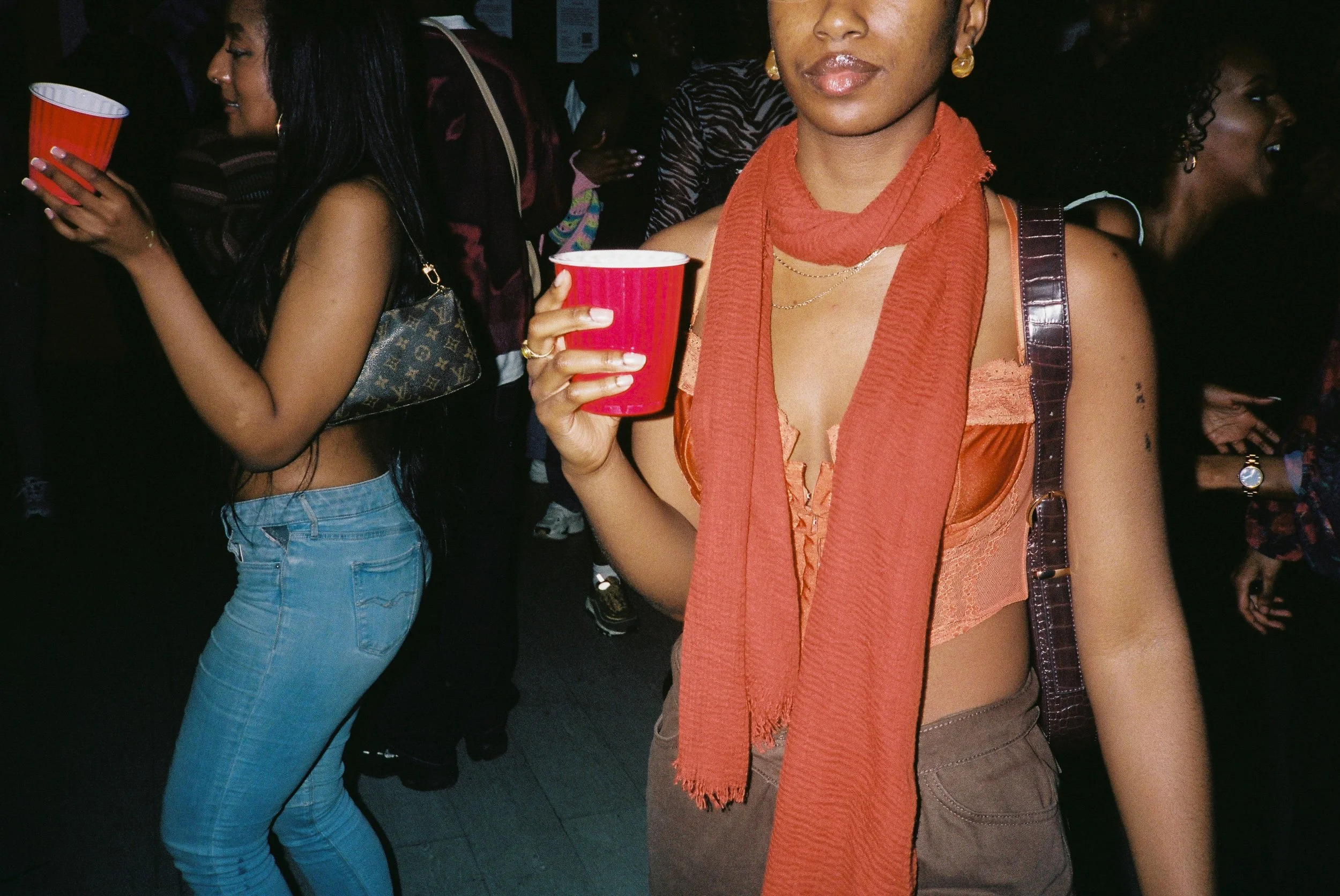 People at a social gathering holding red cups.