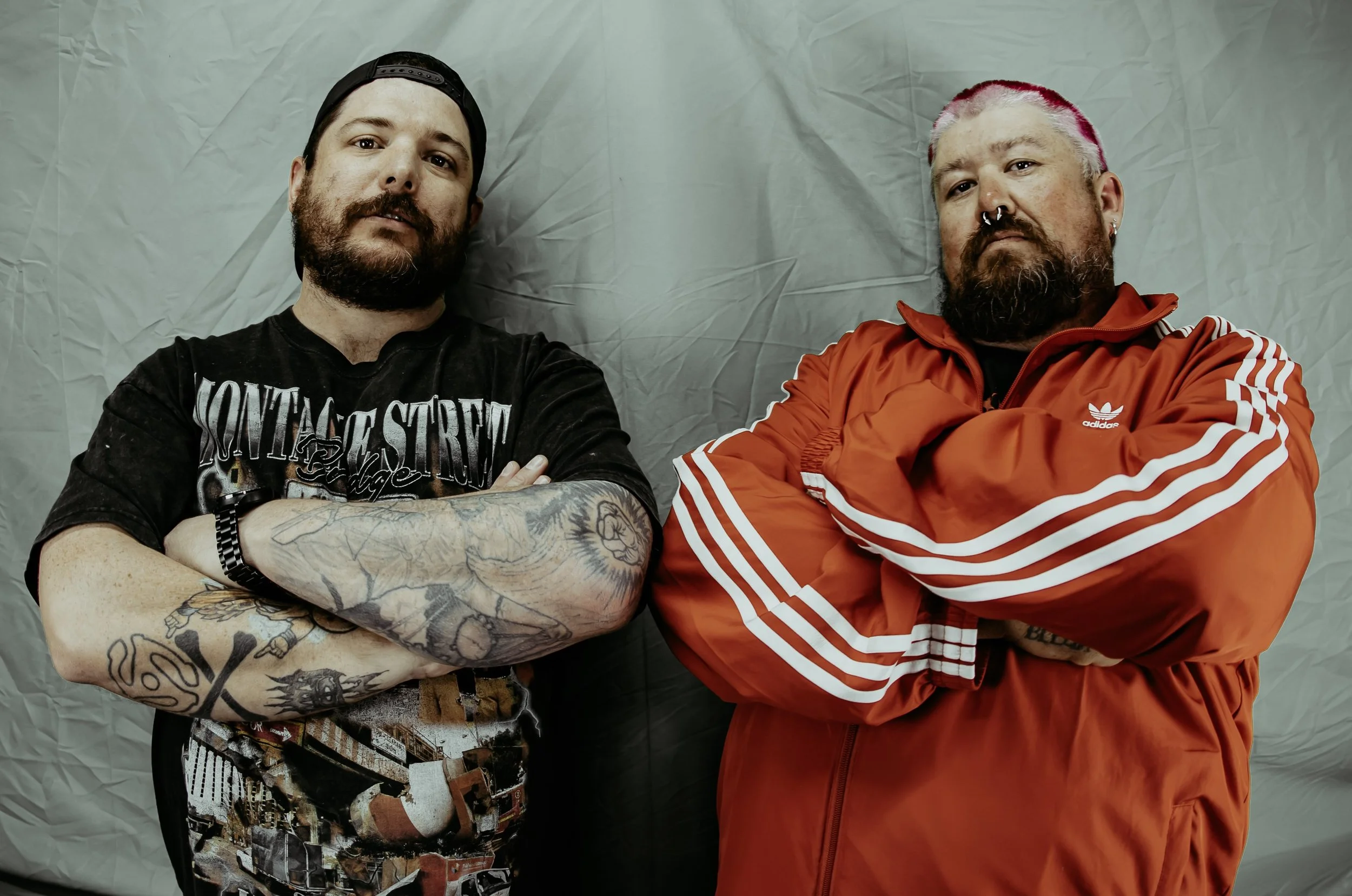 2 old men posing like wankers for a promo photo