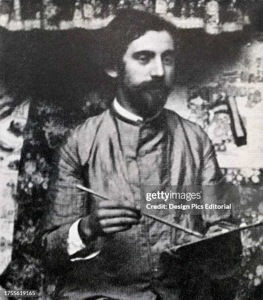 Black and white photo of a man with a beard, sitting outdoors, holding a stick with a pointed end, and reading a book or paper.