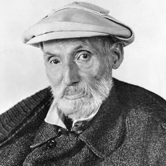 Black and white portrait of an elderly man with a beard, wearing a newsboy cap and a dark coat.