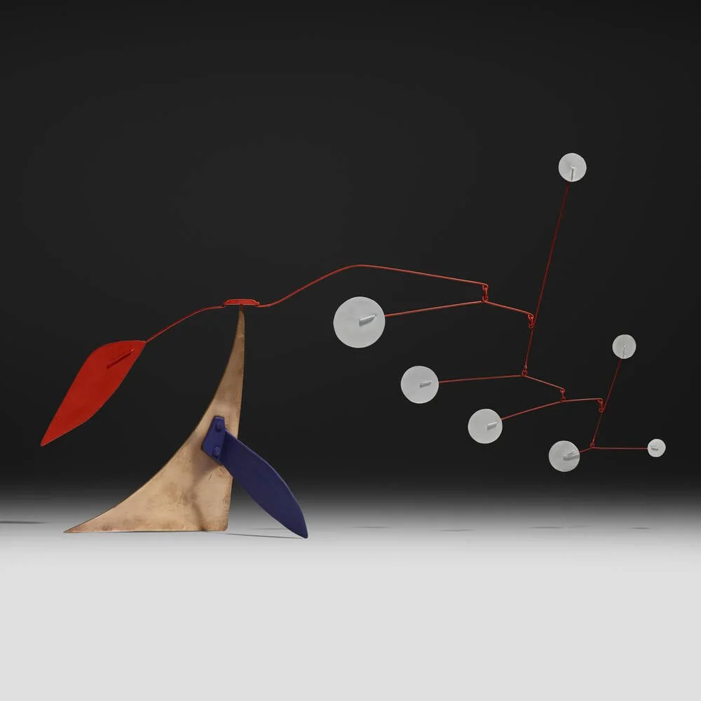 Alexander CALDER(1898-1976)
Red Tail
Modern abstract sculpture with a copper-colored base, red and blue accents, and floating circular white elements connected by red wires against a black background.