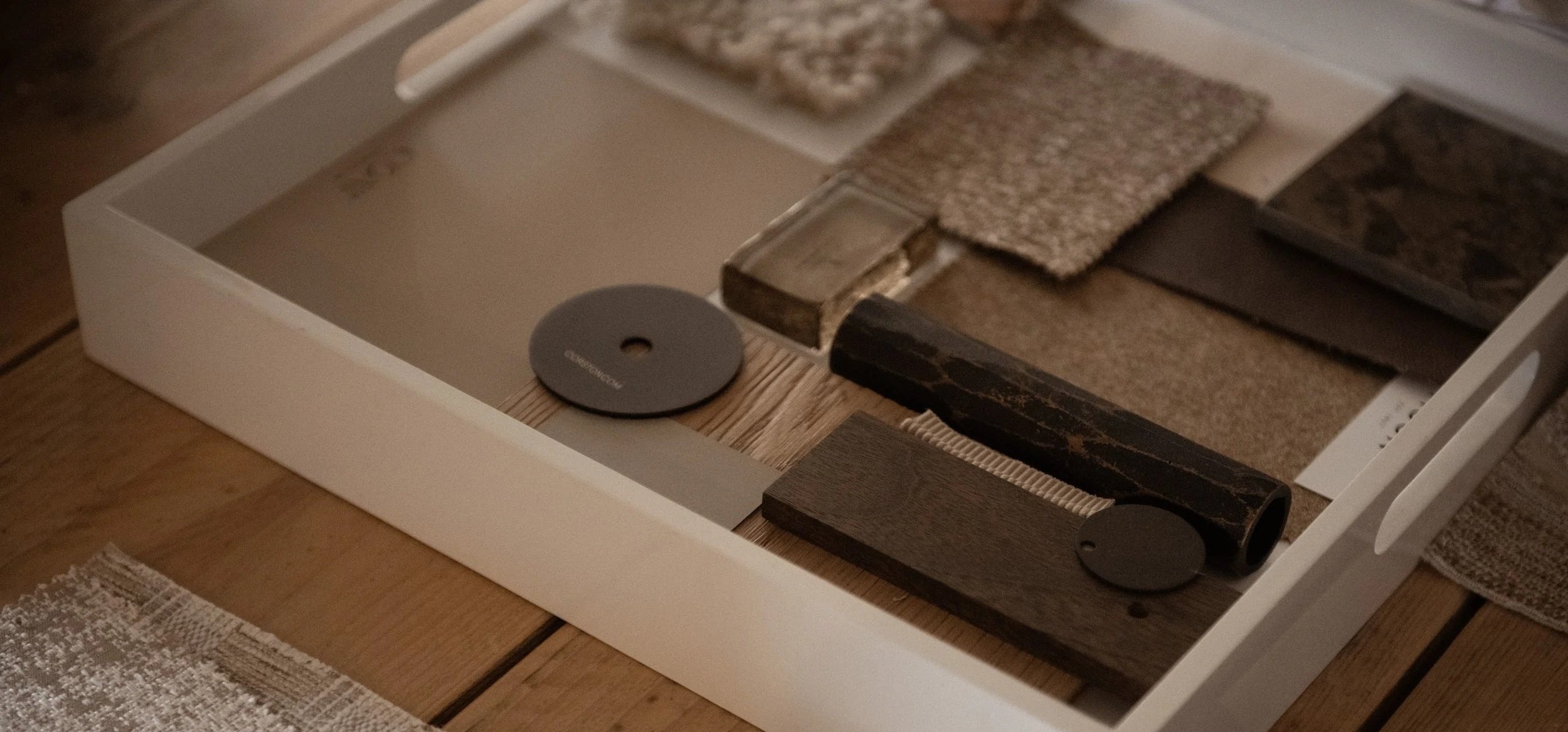 A drawer containing various sample tiles and flooring materials.