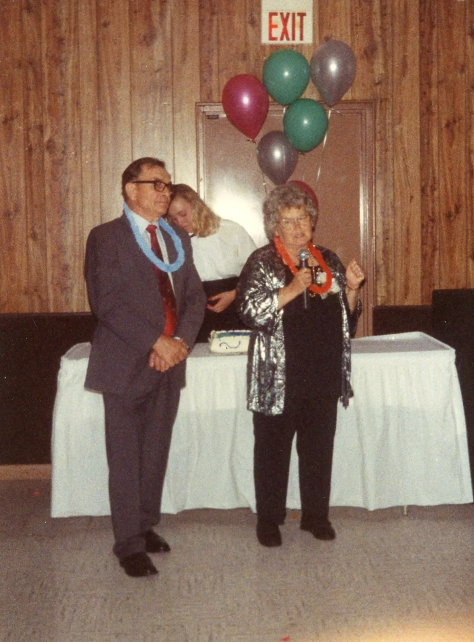 John stands by while Anna addresses the crowd.