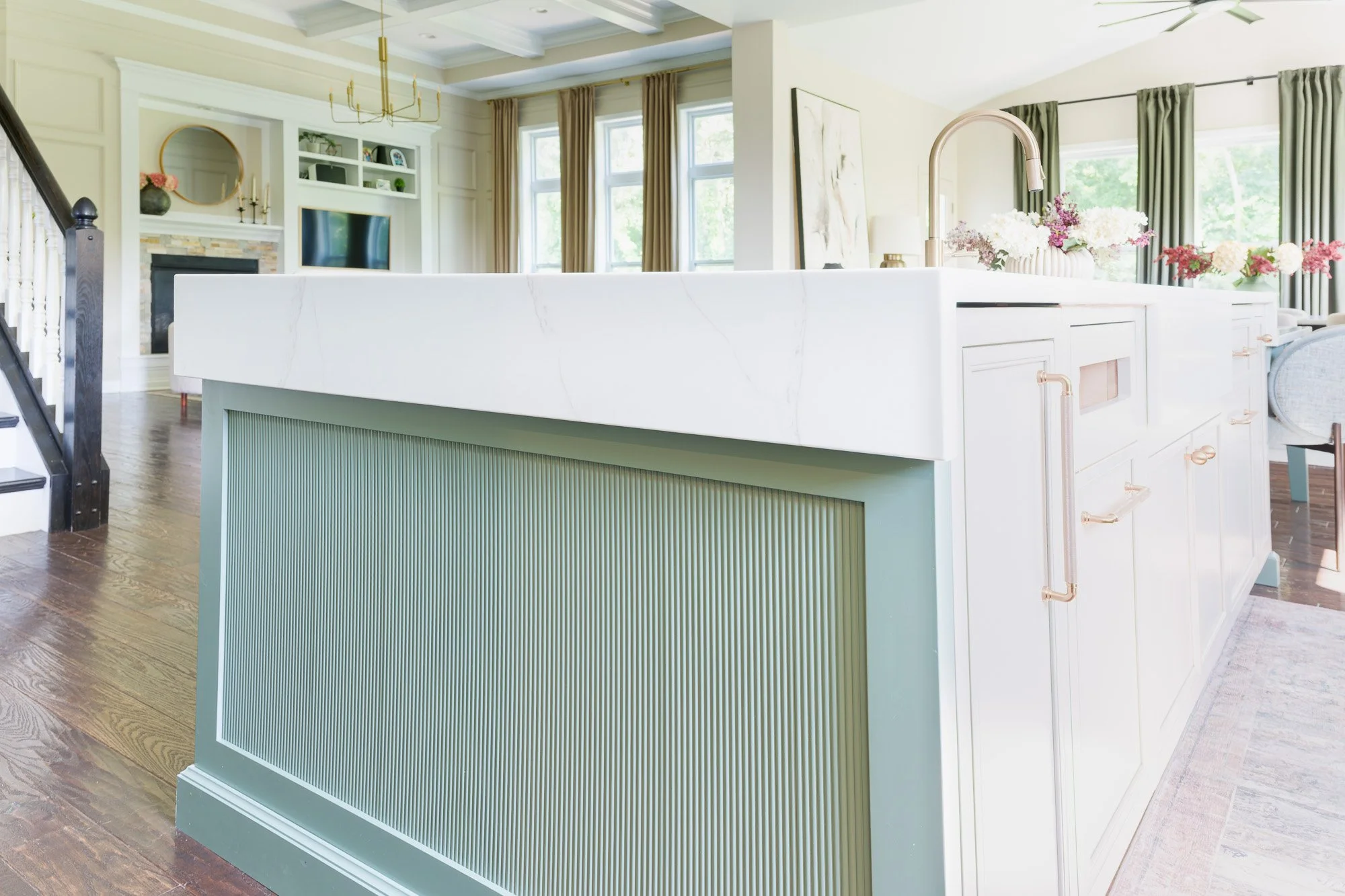 Quartz counters: Quartz countertops with taupe veining and a full countertop backsplash by White Oak Interiors