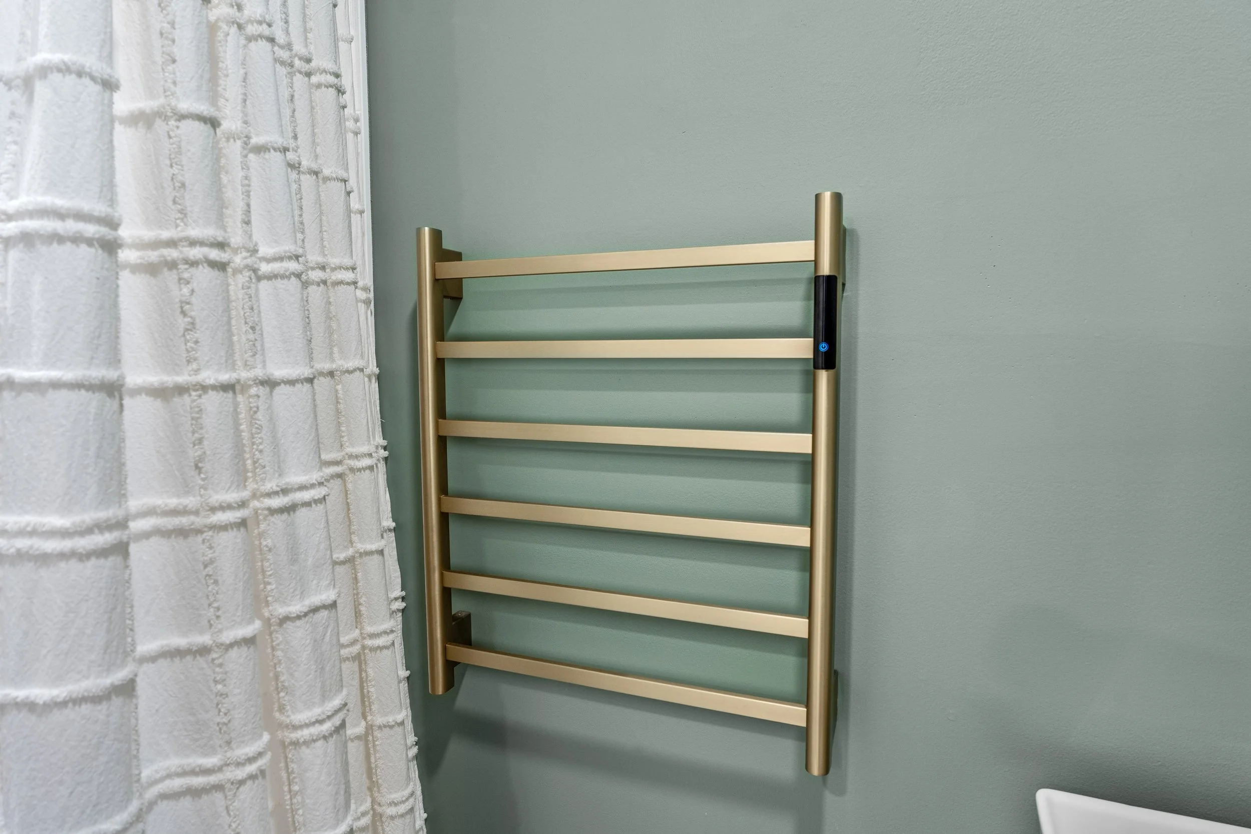 Basement bathroom in Centerville, Ohio with gold towel warmer and evergreen fog walls by White Oak Interiors
