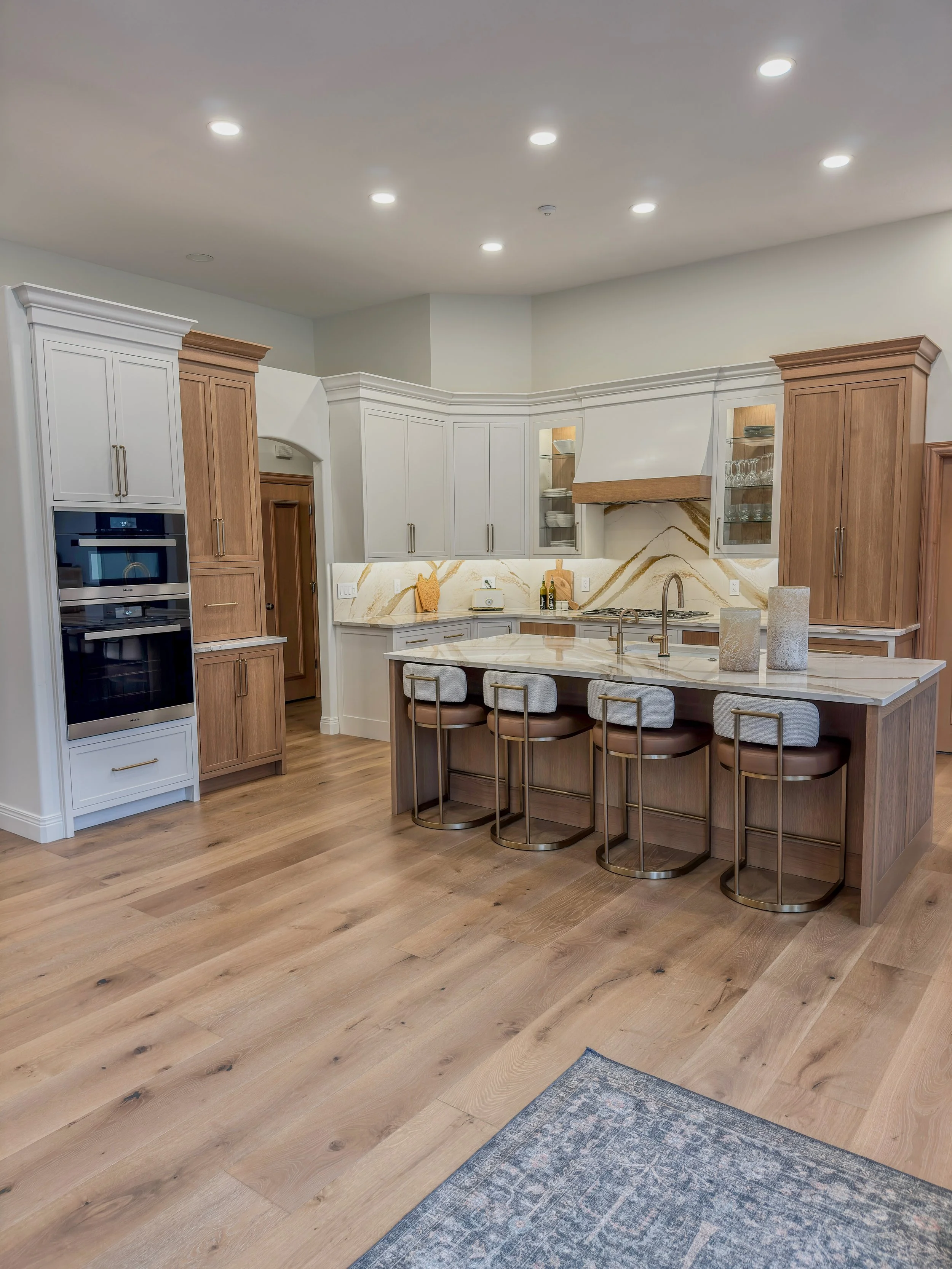 Bellbrook, Ohio kitchen remodel with marble island, bar seating, and white and natural wood cabinetry by White Oak Interiors