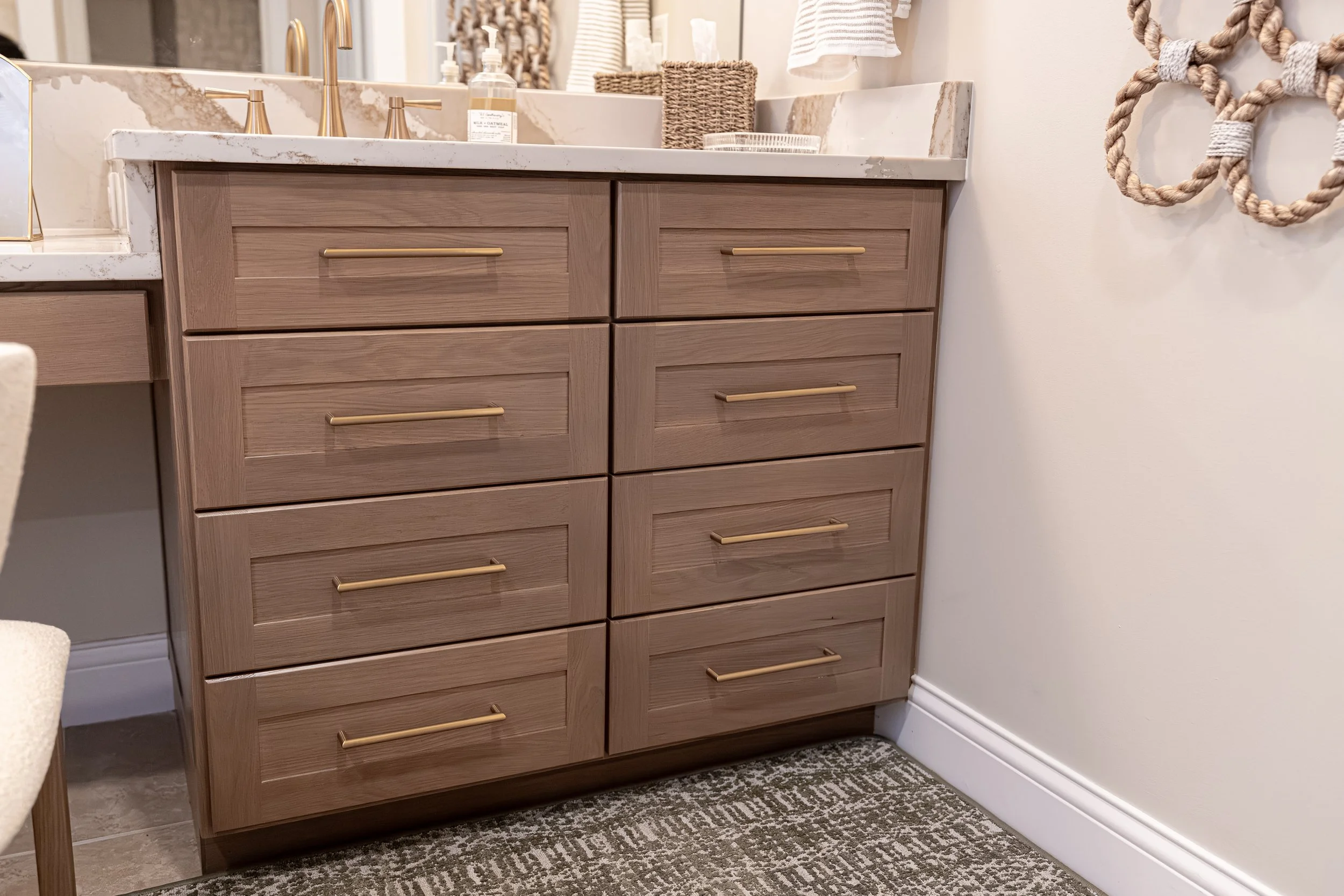 Custom white oak bathroom vanity with brushed gold hardware and quartz countertop in an Oakwood, Ohio master bath renovation