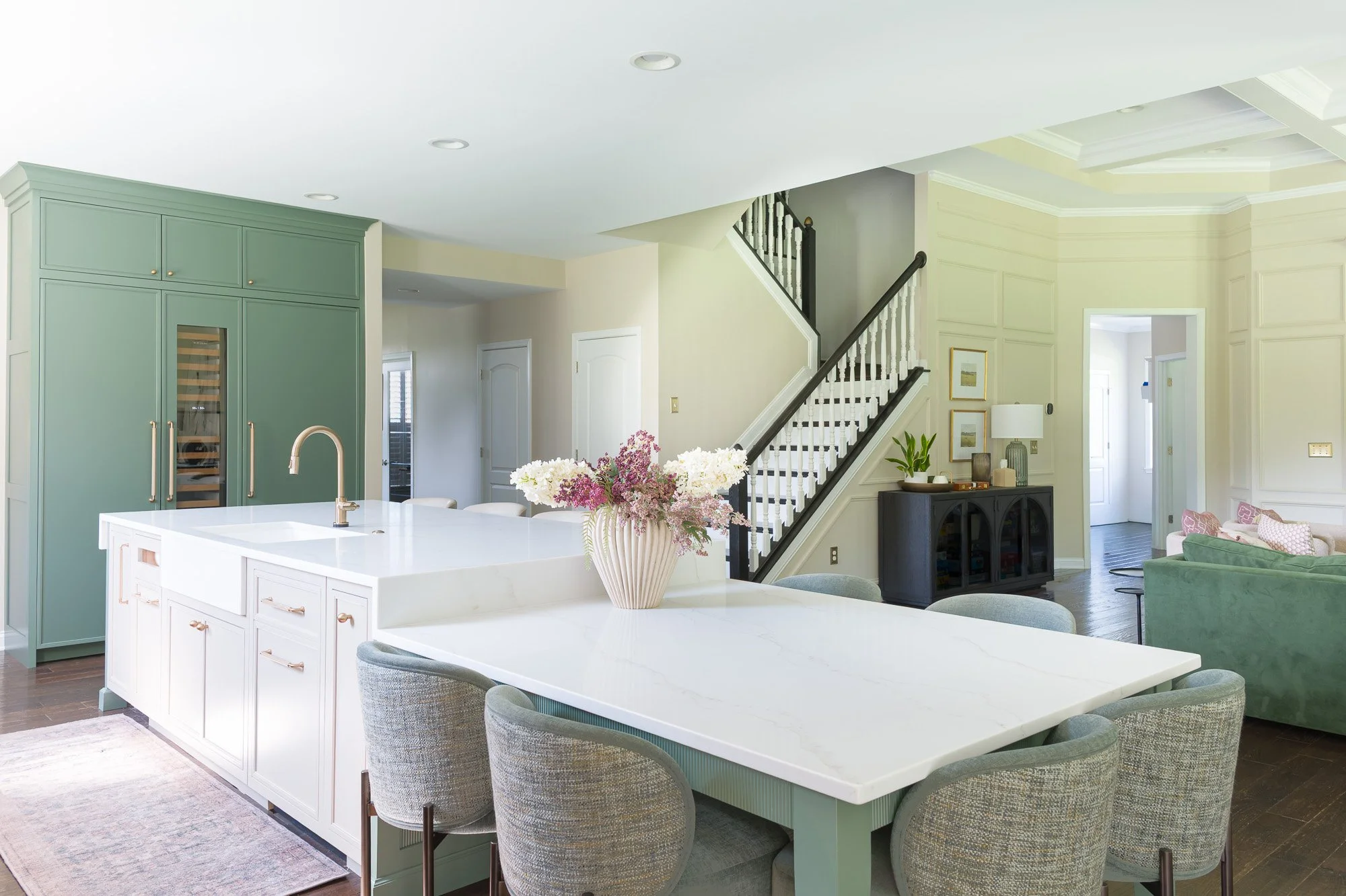 Quartz counters: Quartz countertops with taupe veining and a full countertop backsplash by White Oak Interiors