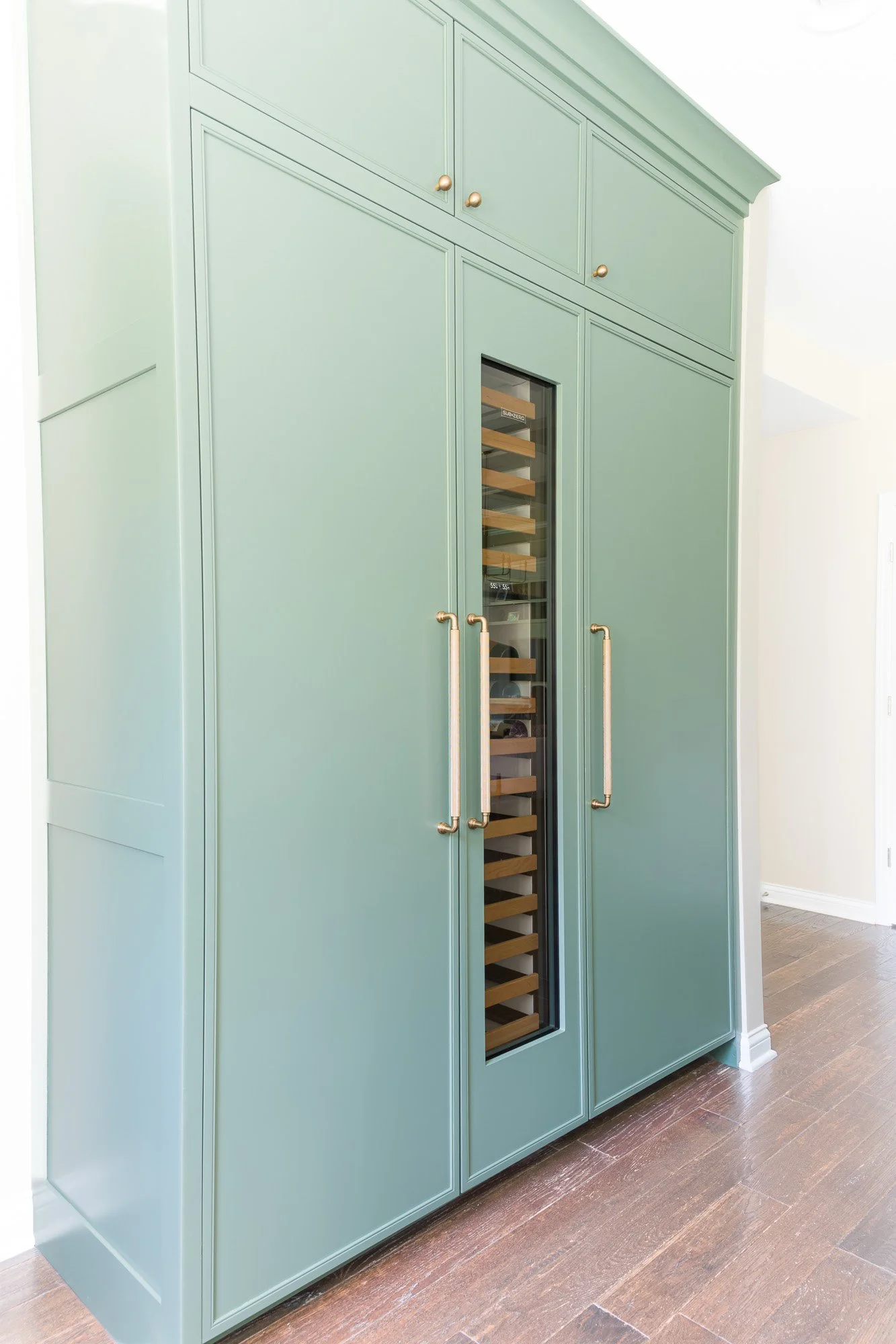 Custom panel-front Sub-Zero built-in refrigerator integrated into taupe cabinetry in a Beavercreek, Ohio kitchen