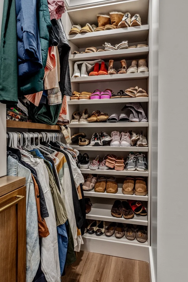 Custom closet with floor-to-ceiling angled shoe storage shelving beside double-hung clothing rods in a Xenia, Ohio master suite