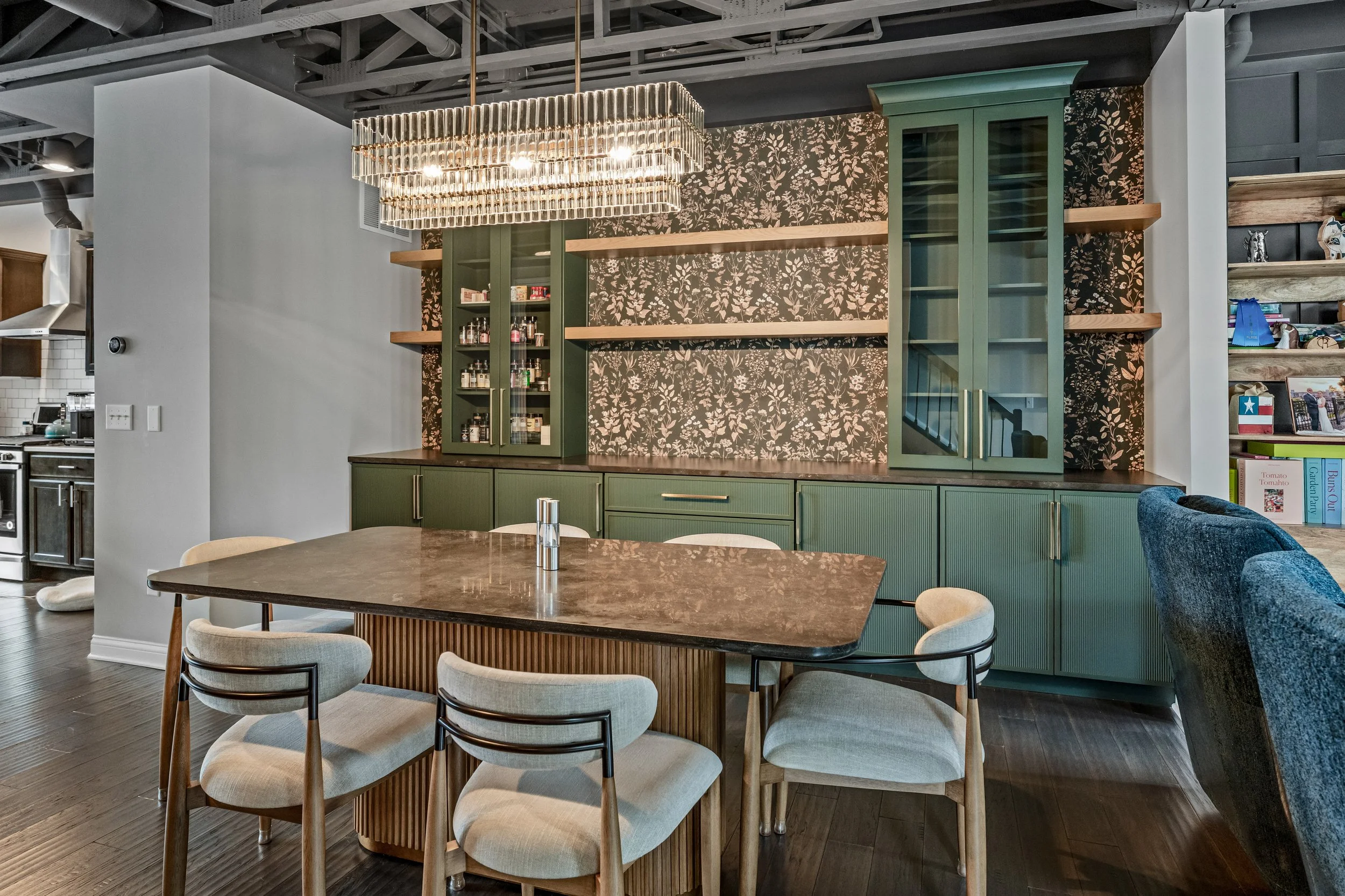 Custom dining room in Springboro, Ohio with green built-in cabinetry, floral wallpaper, and stain-matched wood shelving by White Oak Interiors