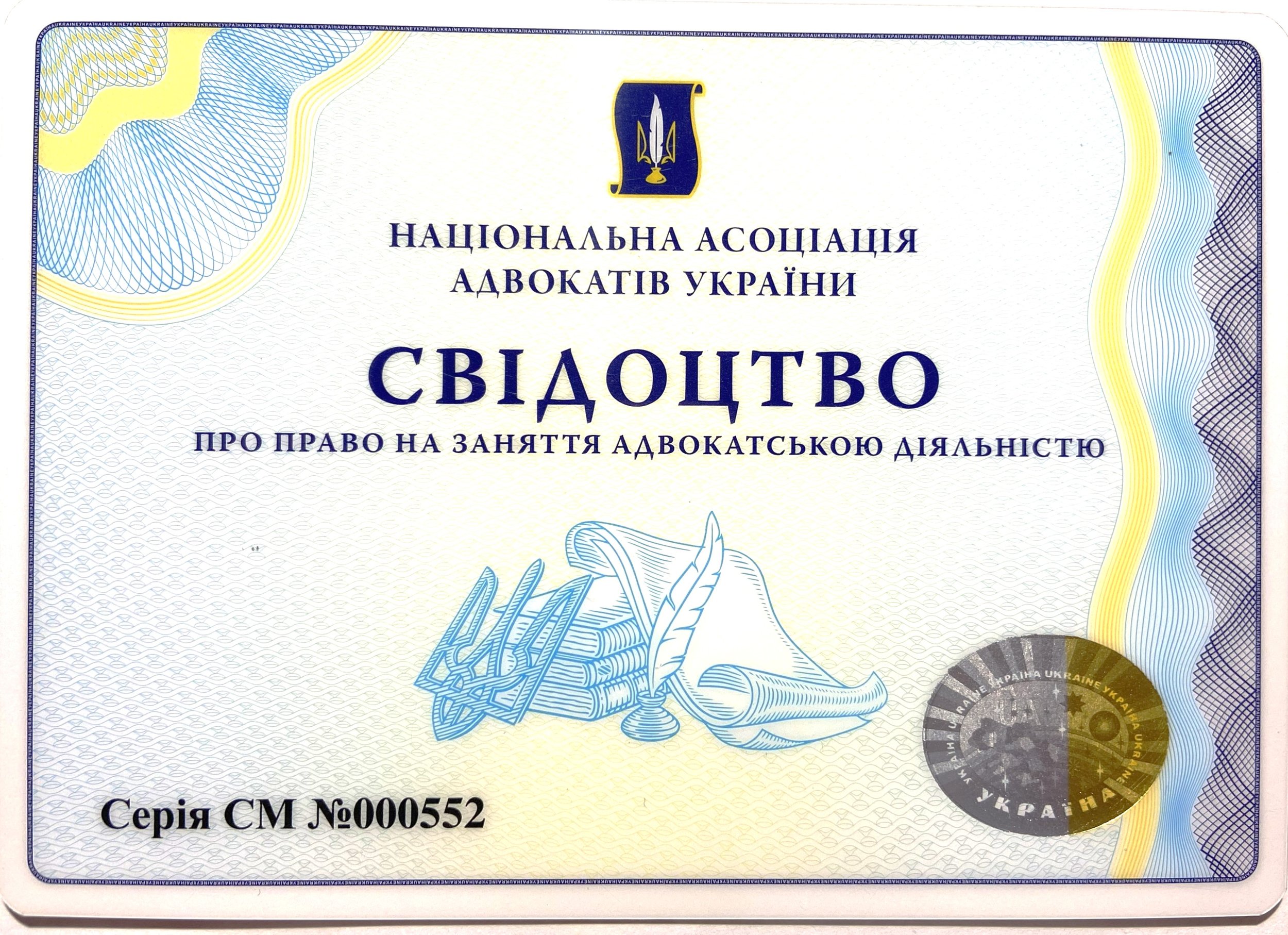 A certificate from the National Association of Advocates of Ukraine, with Ukrainian text and official emblem at the top center, featuring a trident, and decorative blue and yellow patterns on the border and background.